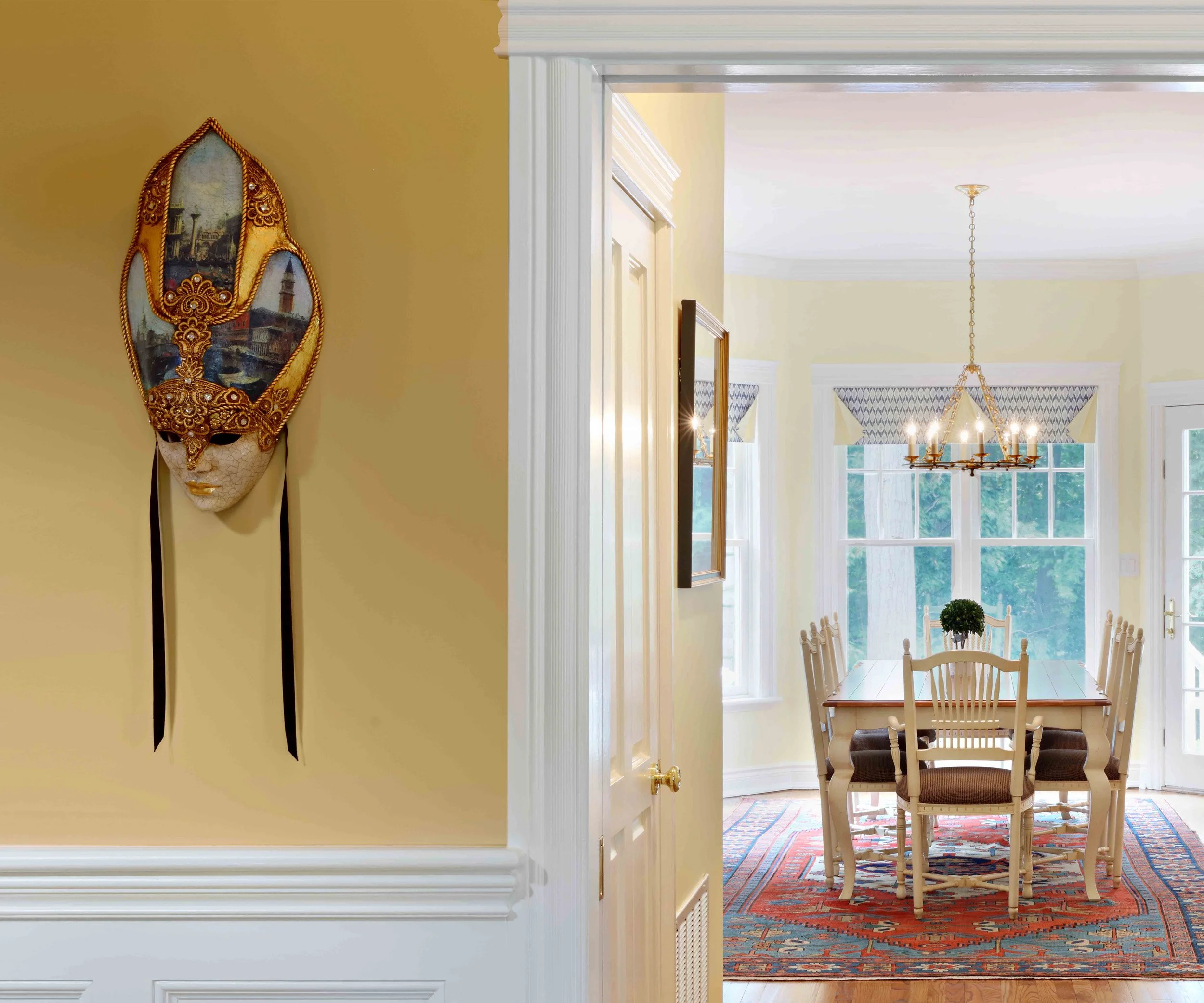 Foyer featuring decorative venetian mask at Lismore House in Greenwich, CT.