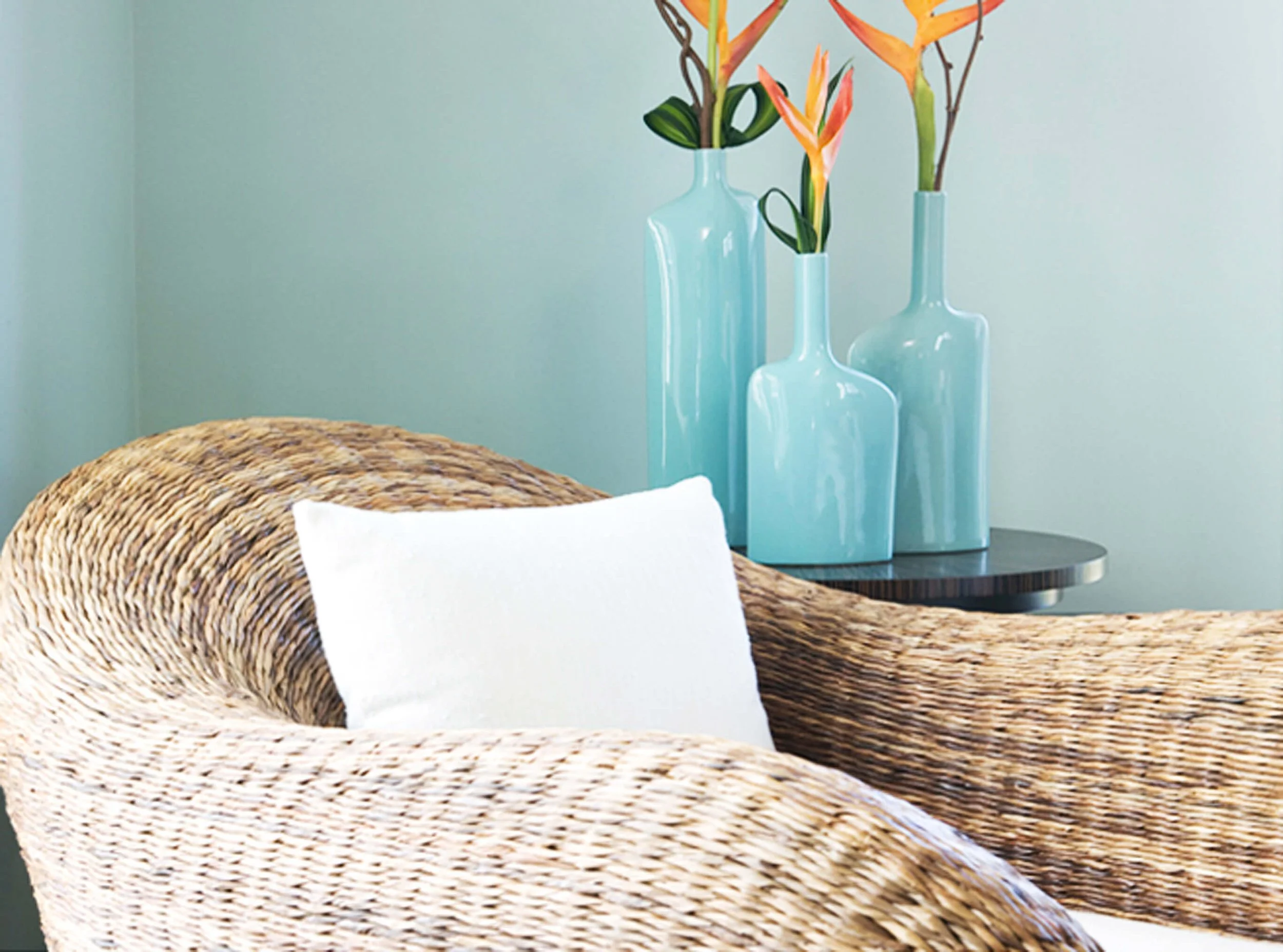 Bedroom detail with woven seating and decorative accents in Grand Cayman guest villa