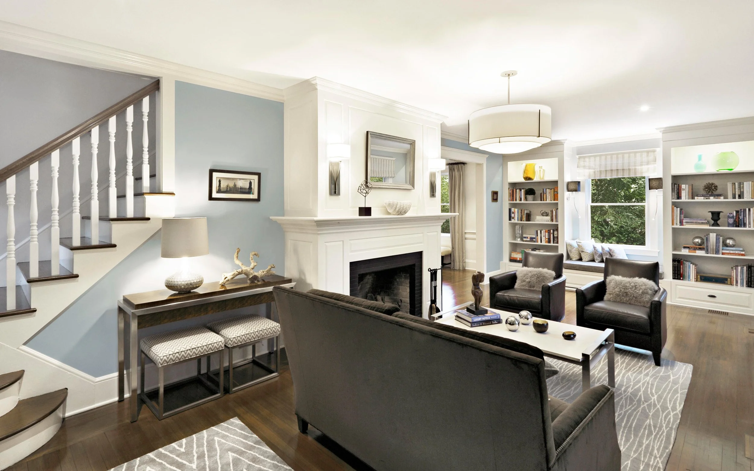 Living room in Indian Field residence in Greenwich, CT designed by Luminosus Designs with tailored seating and fireplace.