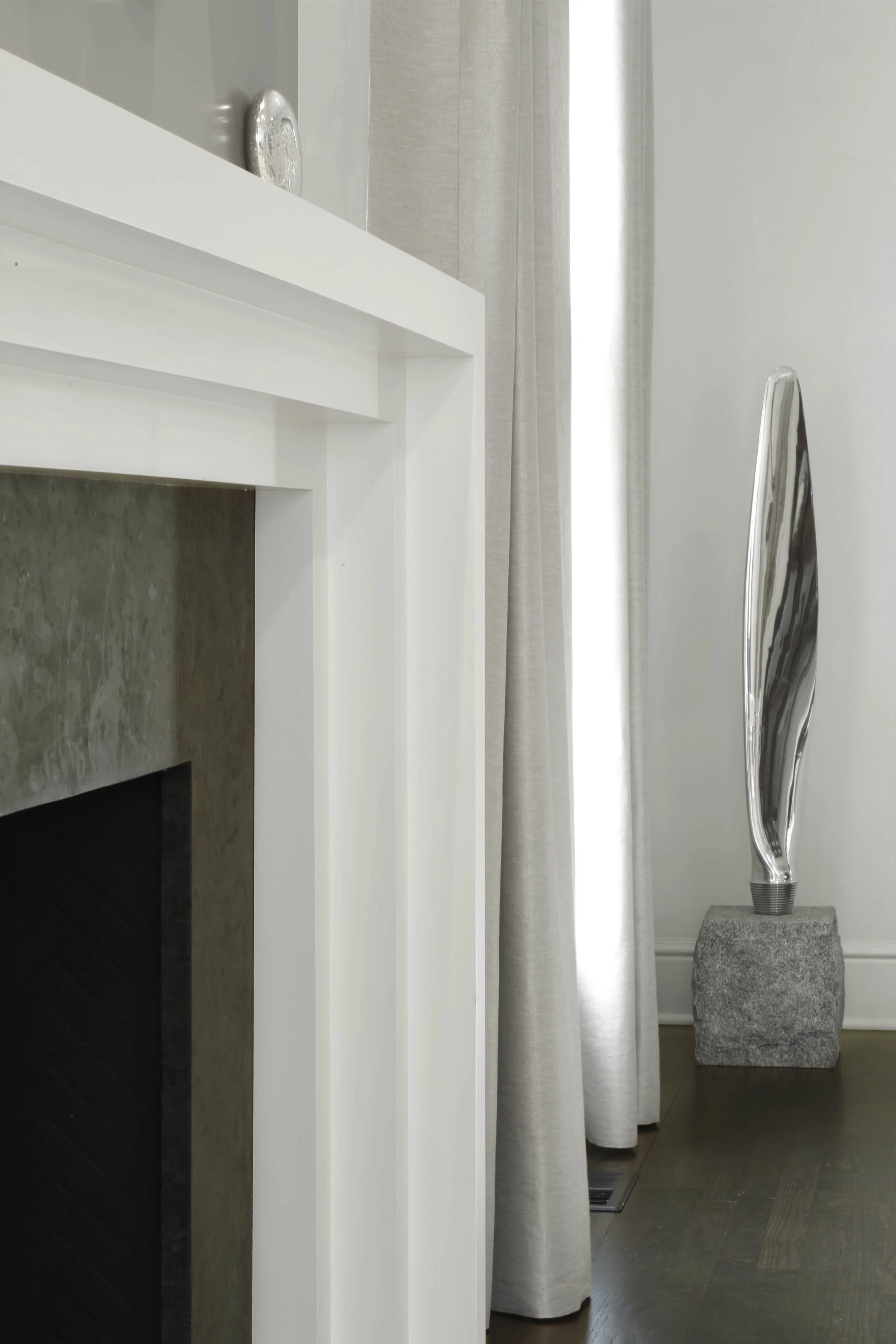 Living room at the Meeting House in Greenwich, CT with a modern fireplace wall, layered seating, and soft neutral finishes.