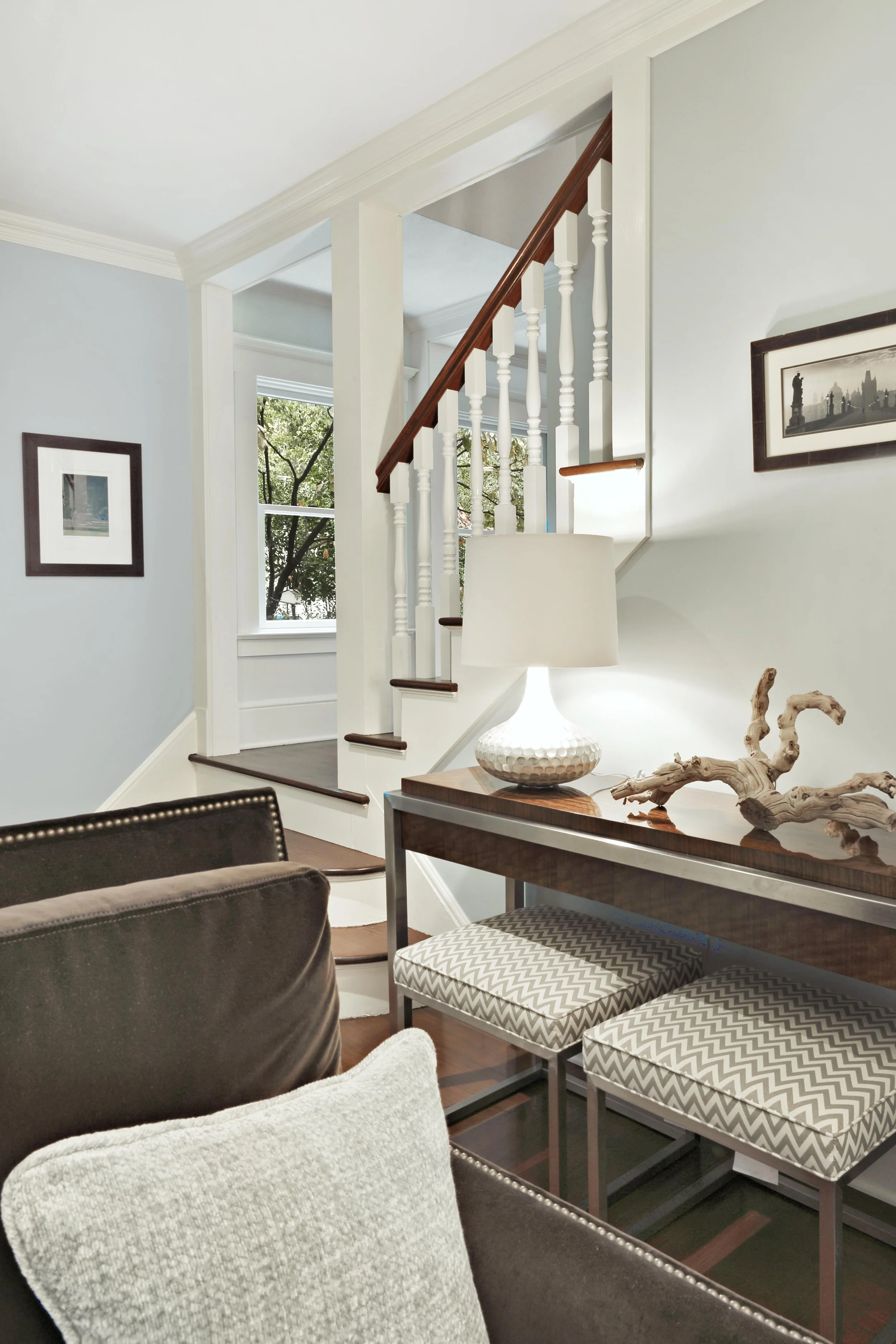 Console table detail styled against living room wall.