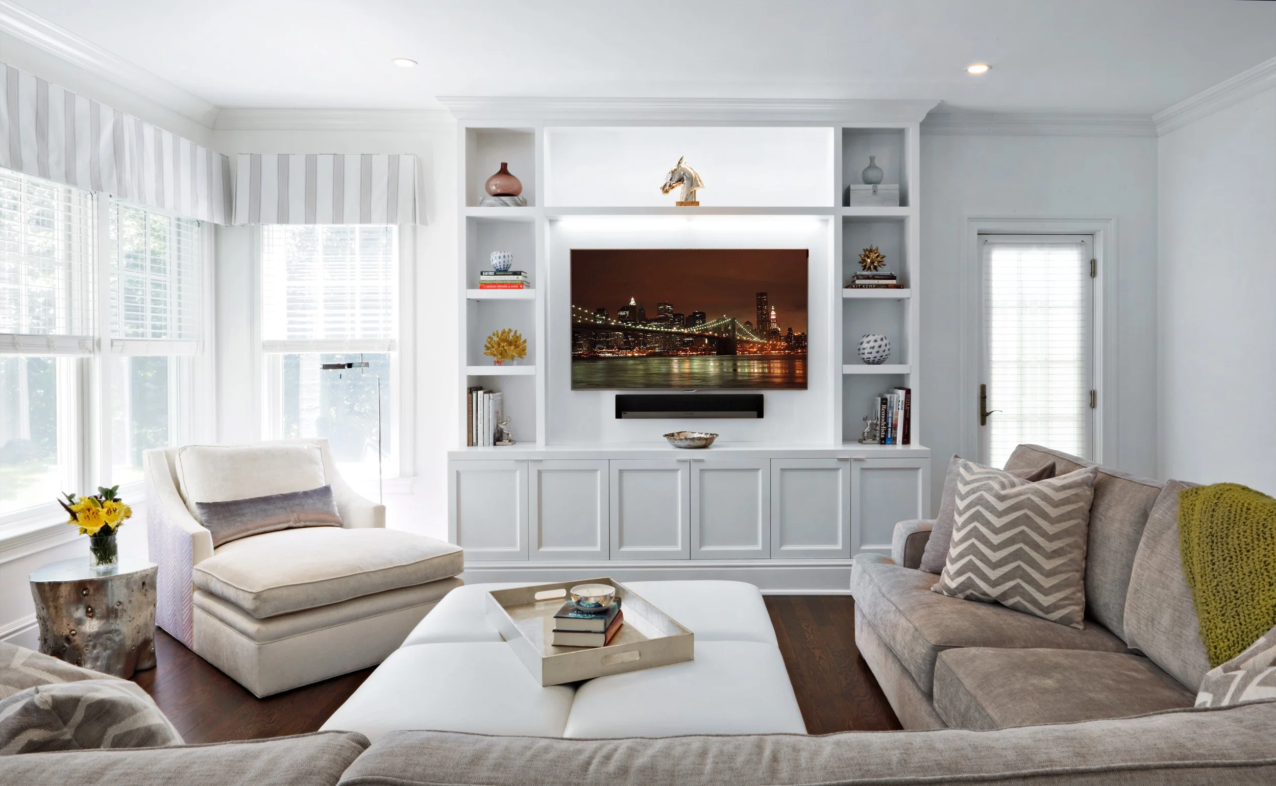 Family room in Parkfield House in Scarsdale NY home with stone fireplace designed by Luminosus Designs.