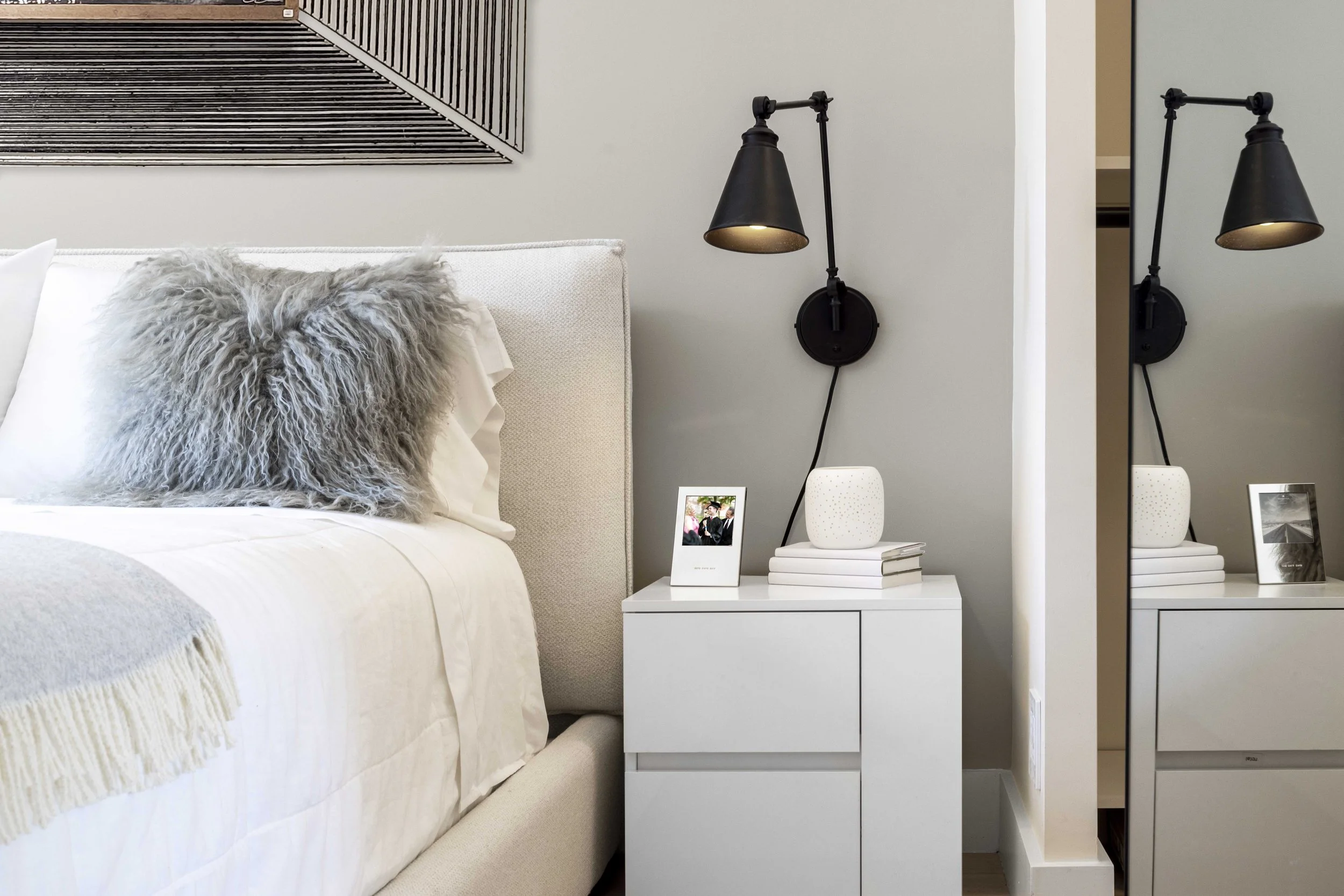 Close-up of the side table and wall sconce in the Gramercy Arms NYC sleeping alcove.