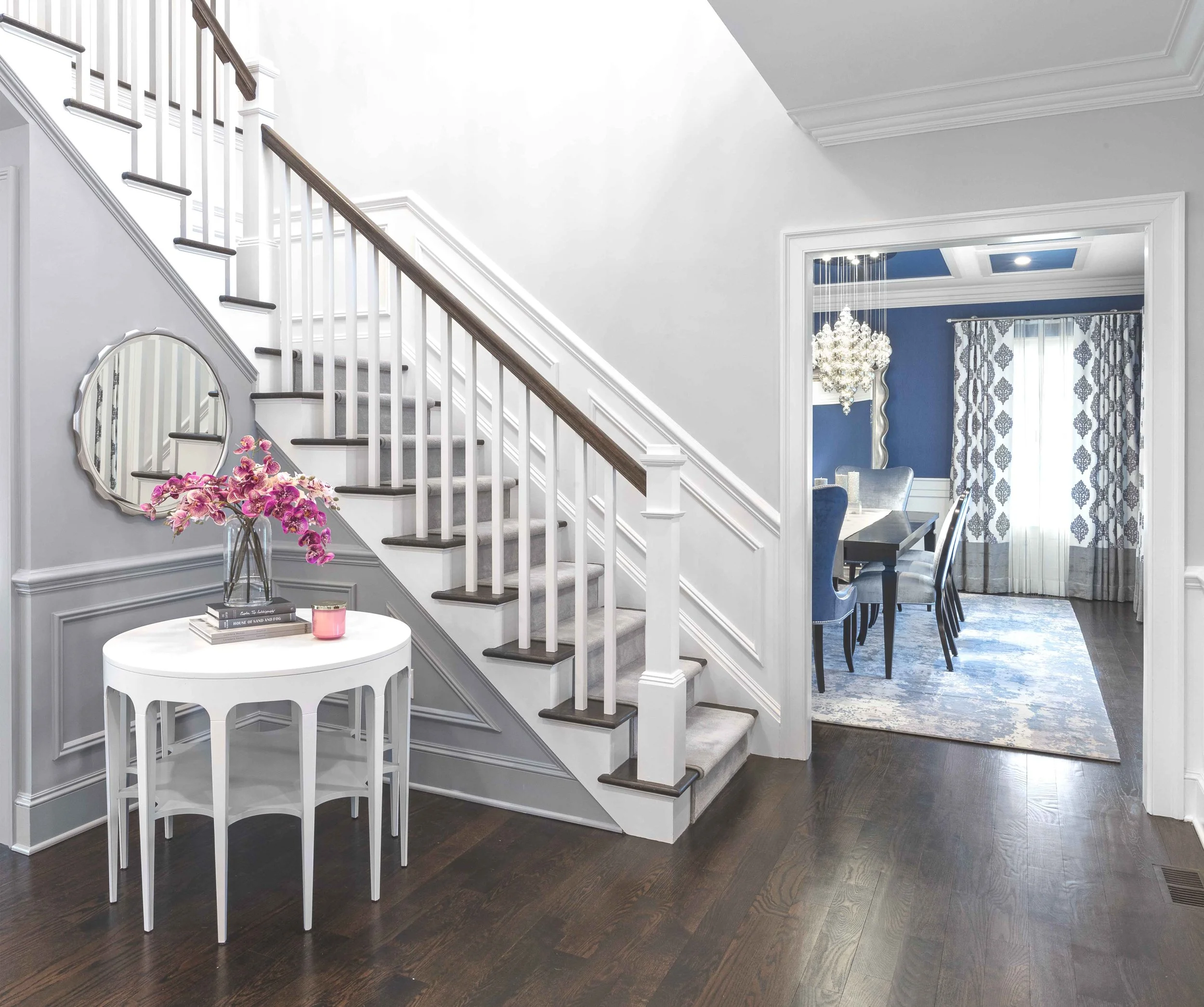 Wide view of the Glen Oaks foyer in Rye, NY, establishing a welcoming entry designed by Luminosus Designs.
