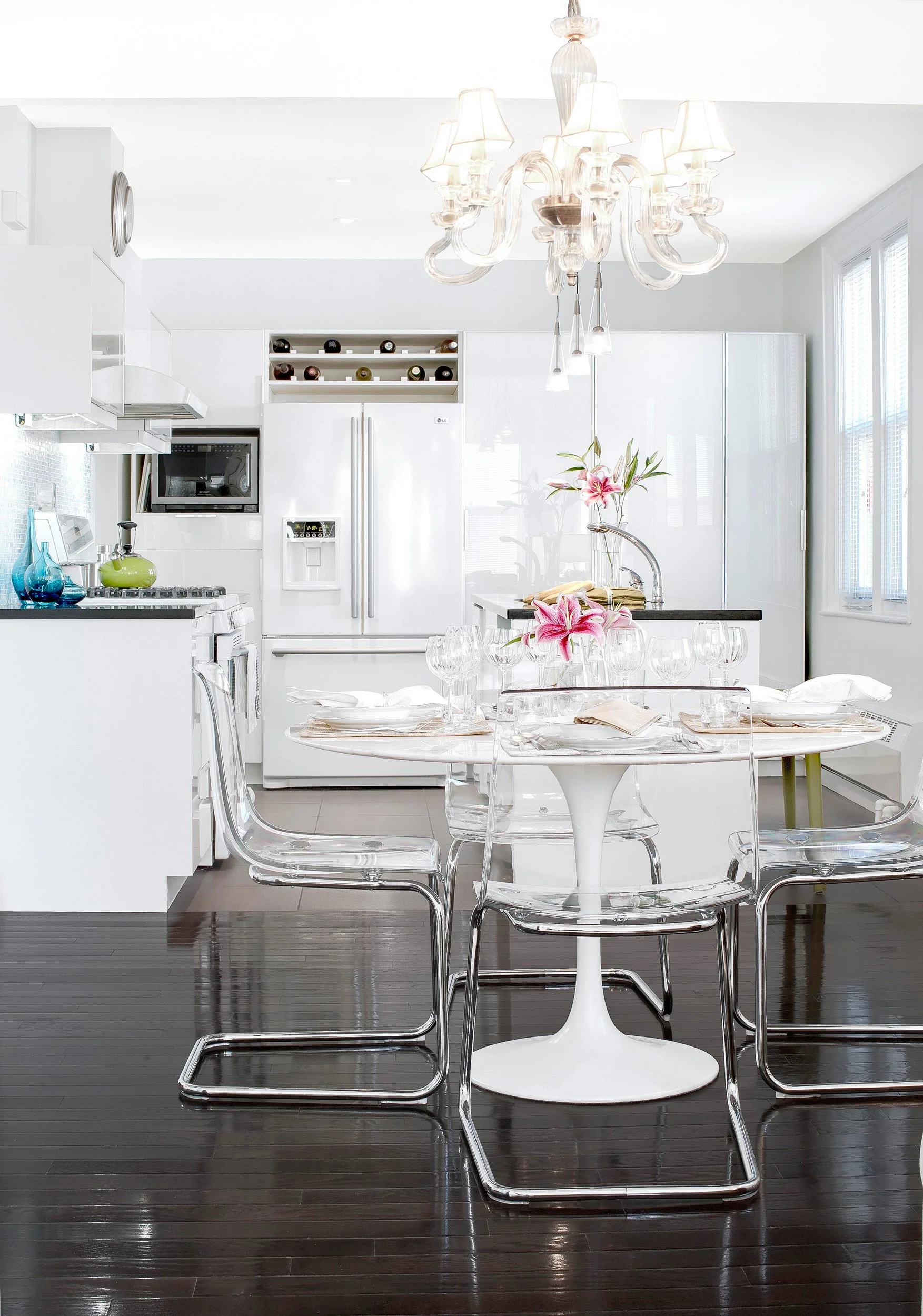 Close-up of a modern dining area with a view to the kitchebn beyond at the Muliner House in Bronx.