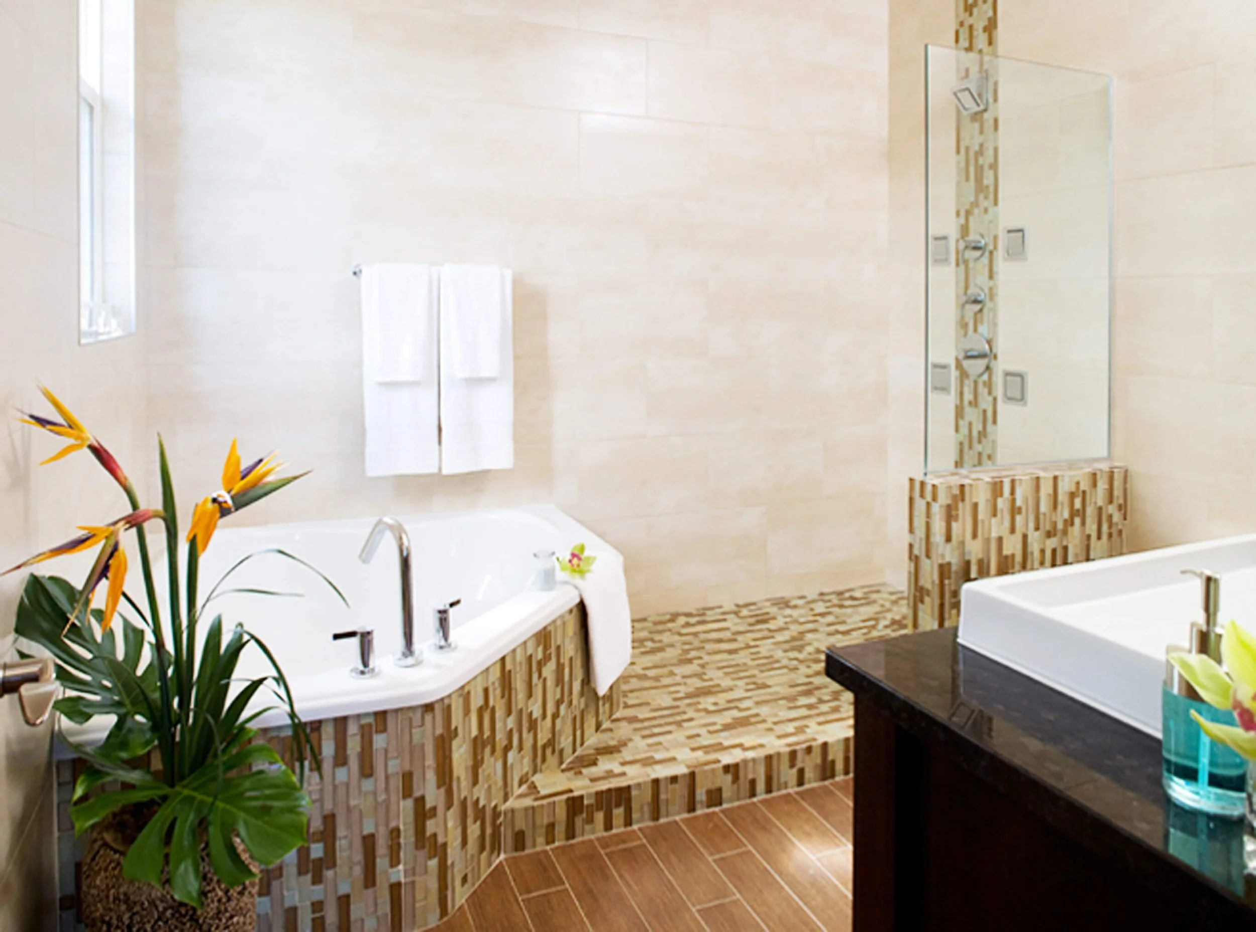 Bathroom with soaking tub and walk-in shower in Grand Cayman guest villa.