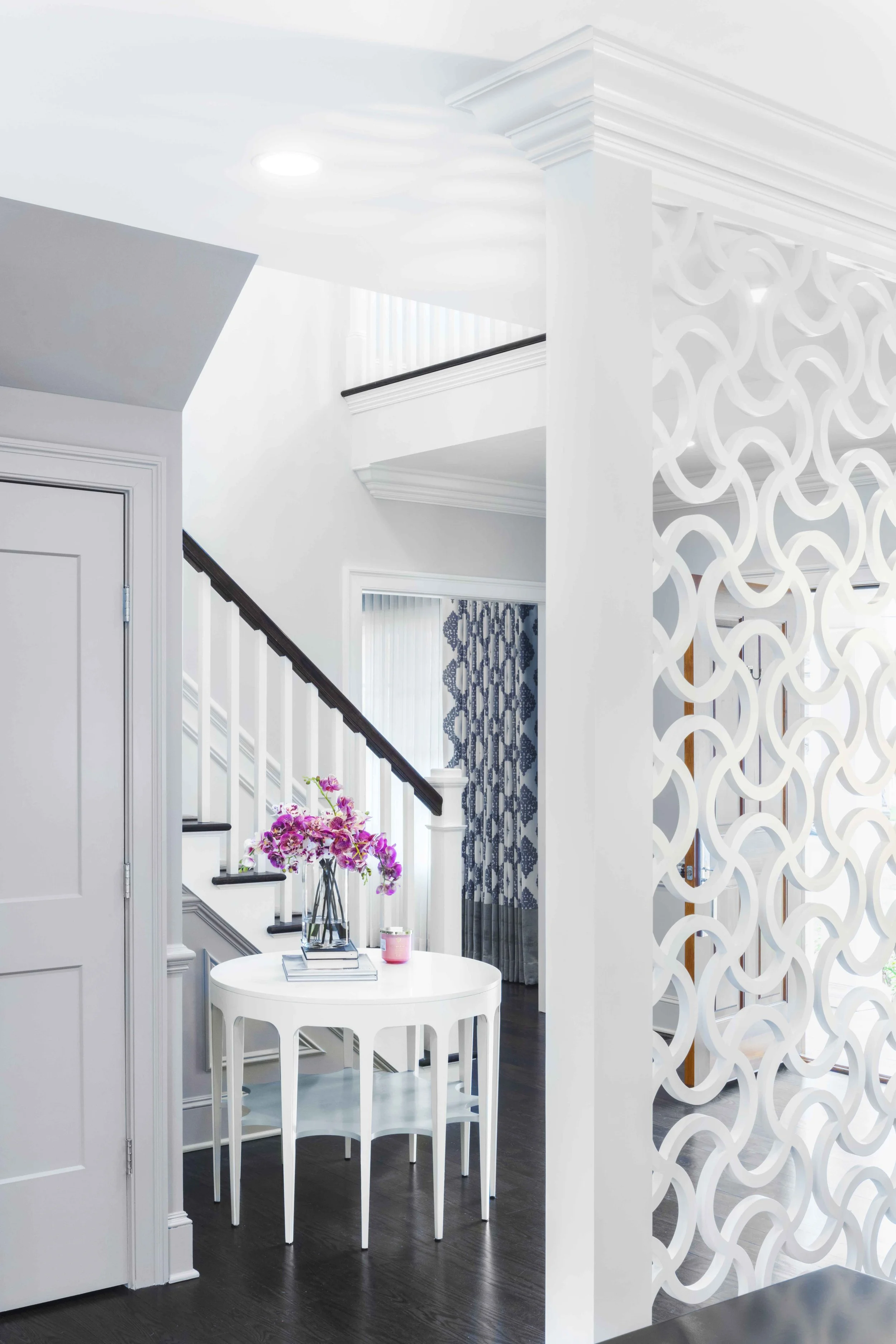 Close-up view of stair, hall table, and custom screen divider in the Glen Oaks, Rye NY foyer.
