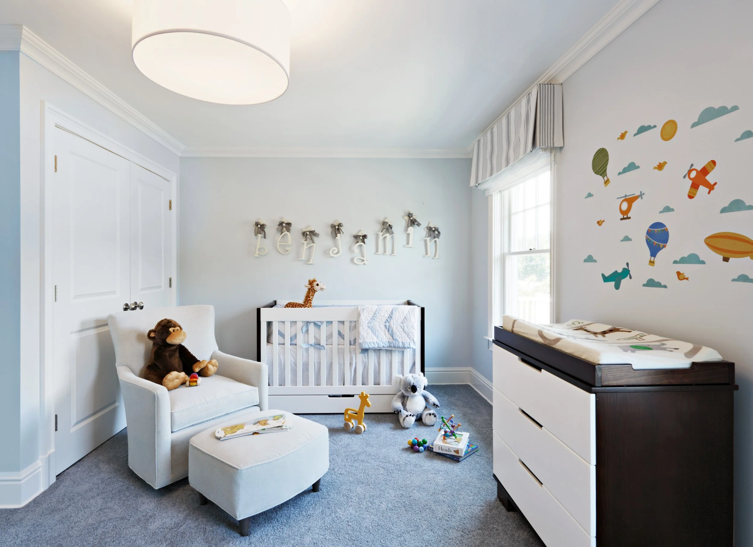 Boy’s bedroom in Parkfield House in Scarsdale NY home featuring soft neutral finishes and tailored furnishings by Luminosus Designs.