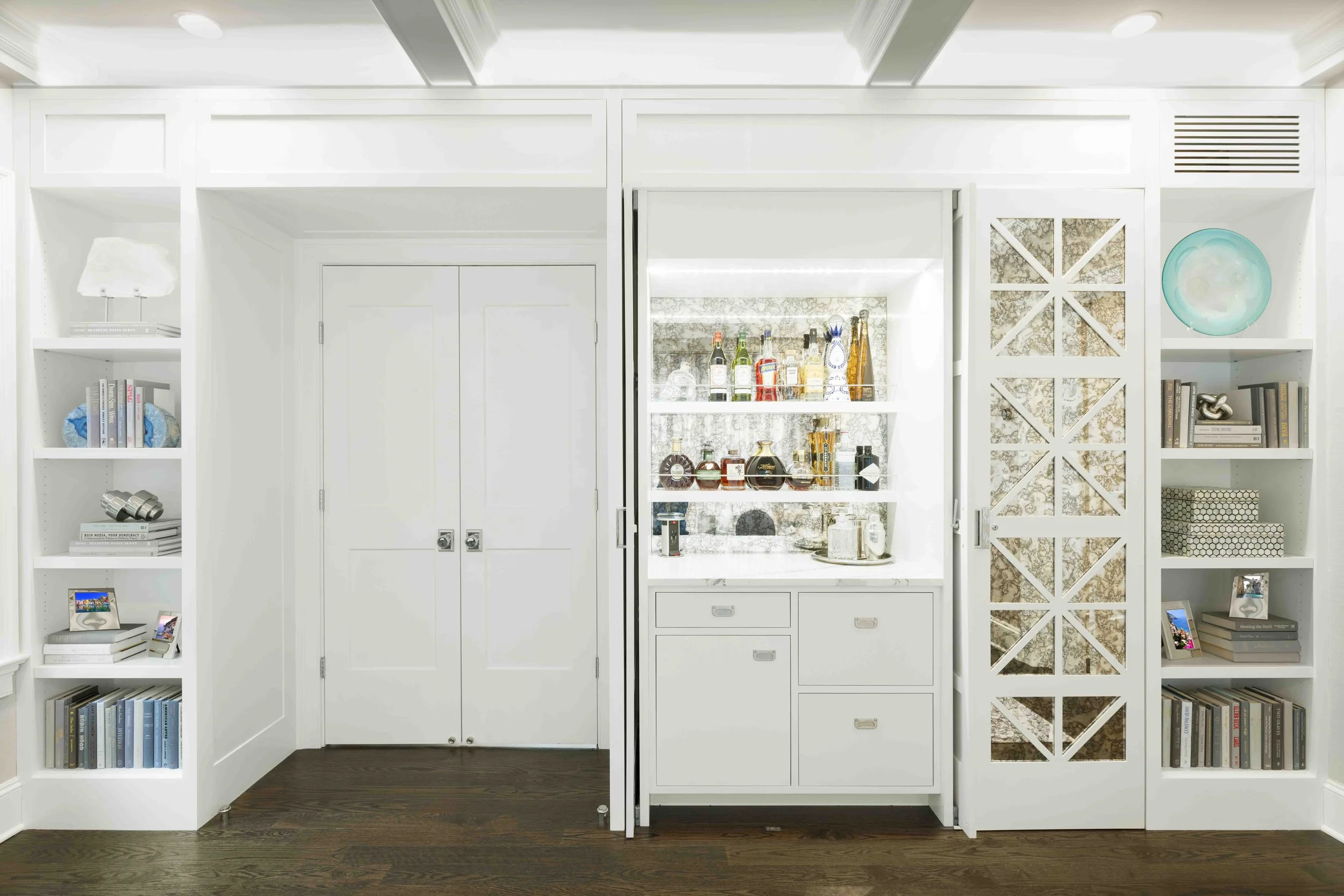 Alternateview of the custom bookcase and bar cabinet in the Glen Oaks, Rye, NY living room, showing surround and finish details.