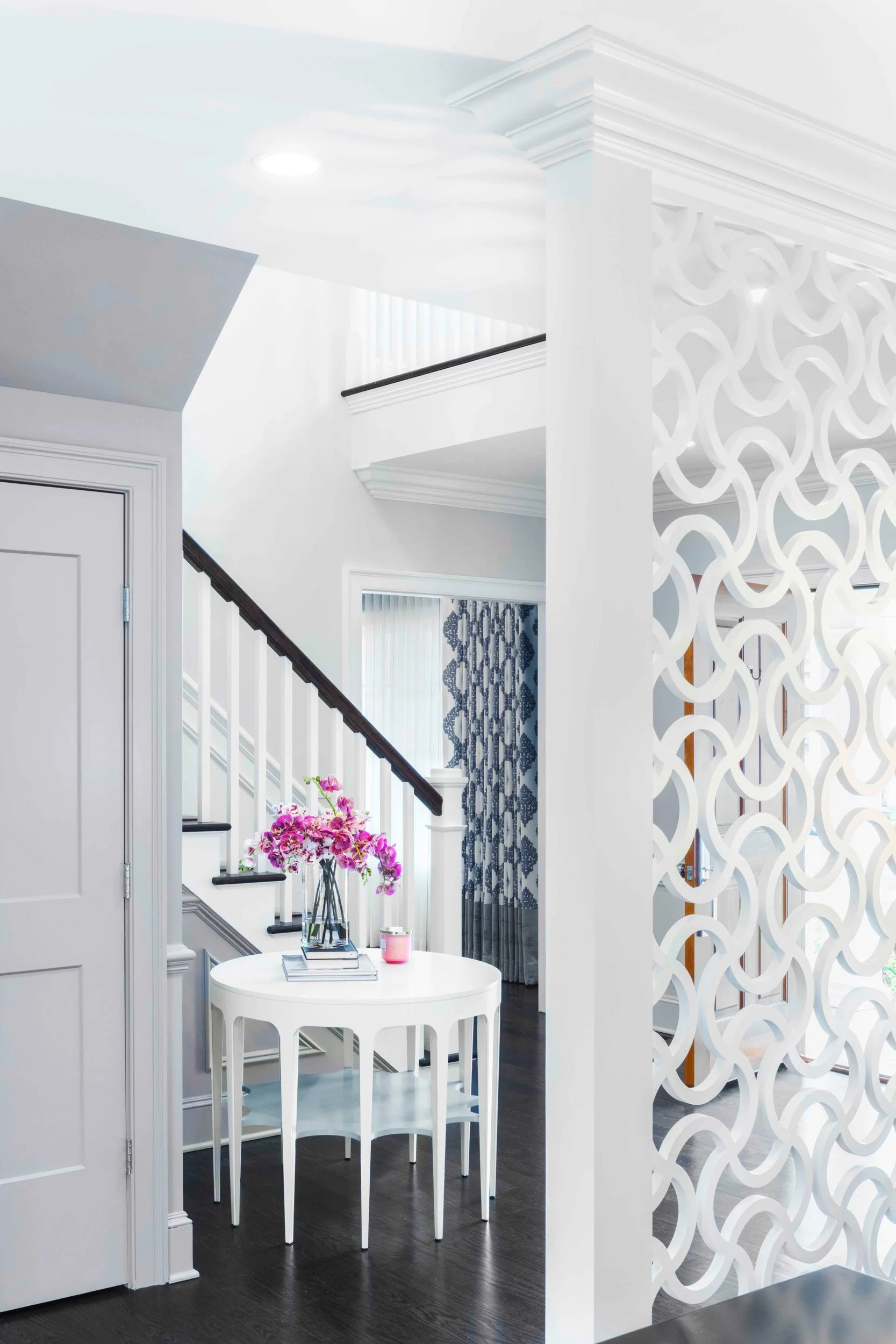 Close-up view of stair, hall table, and custom screen divider in the Glen Oaks, Rye NY foyer.