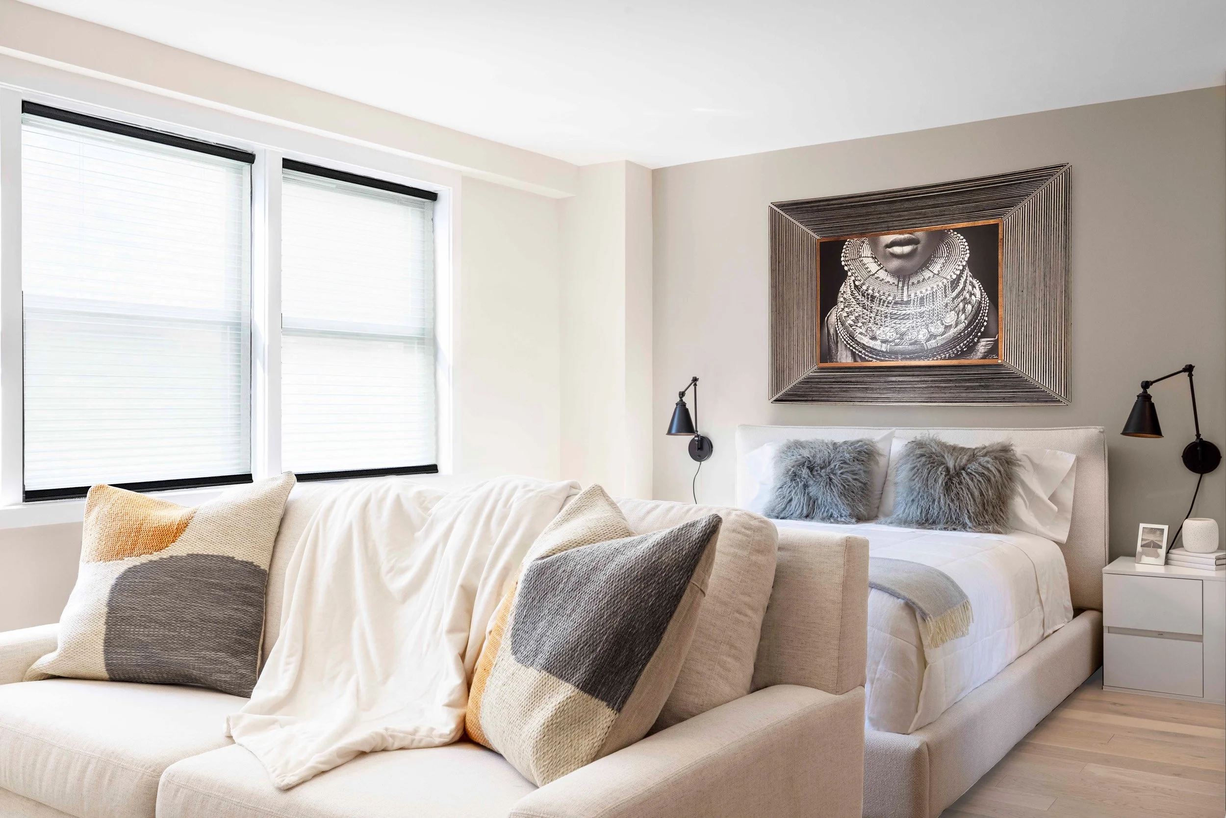 Wide view of the Gramercy Arms sleeping alcove in New York City, featuring dramatic art, soft textiles, and thoughtful space planning by Luminosus Designs.