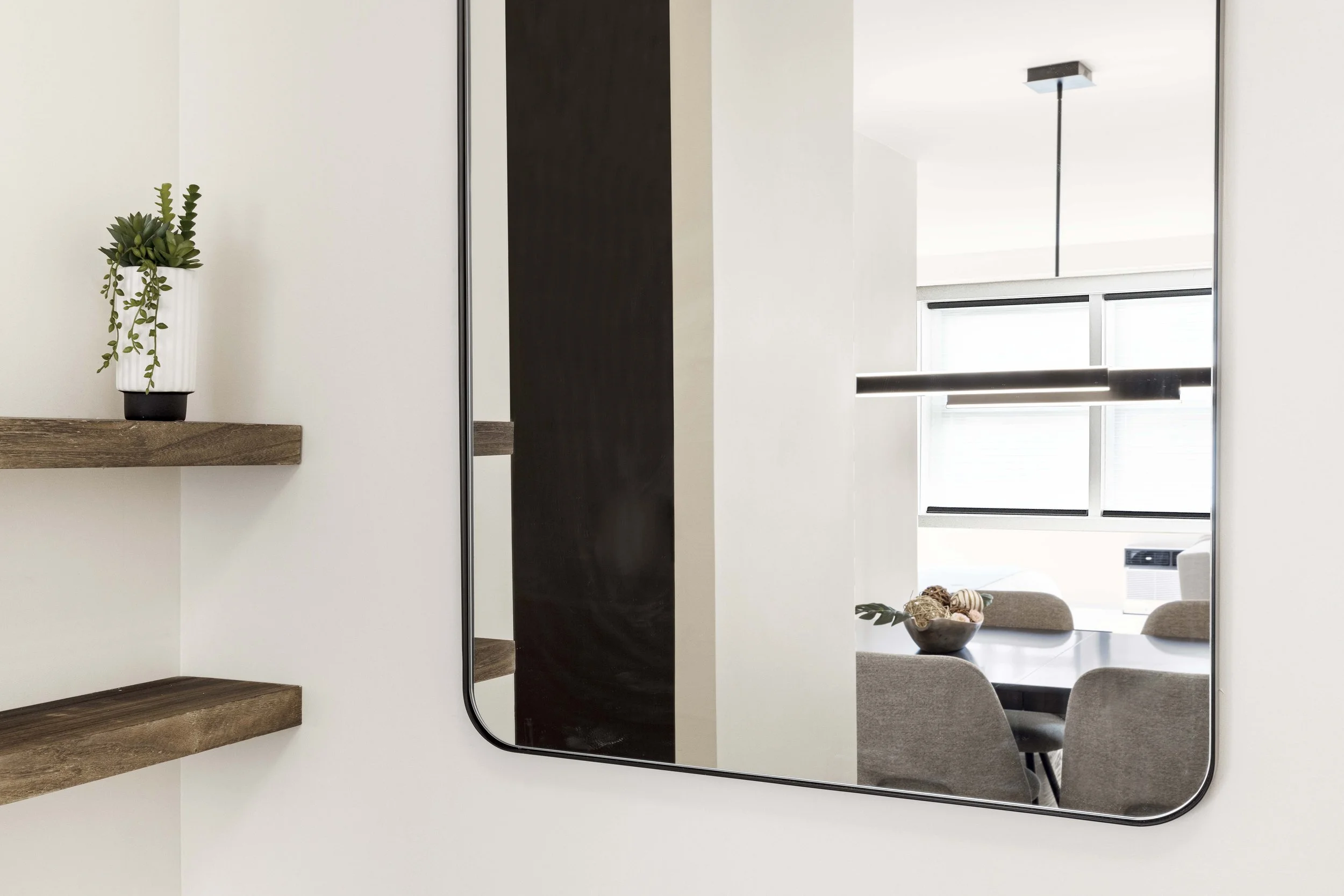 Detail view of foyer mirror and shelving in the Gramercy Arms apartment.