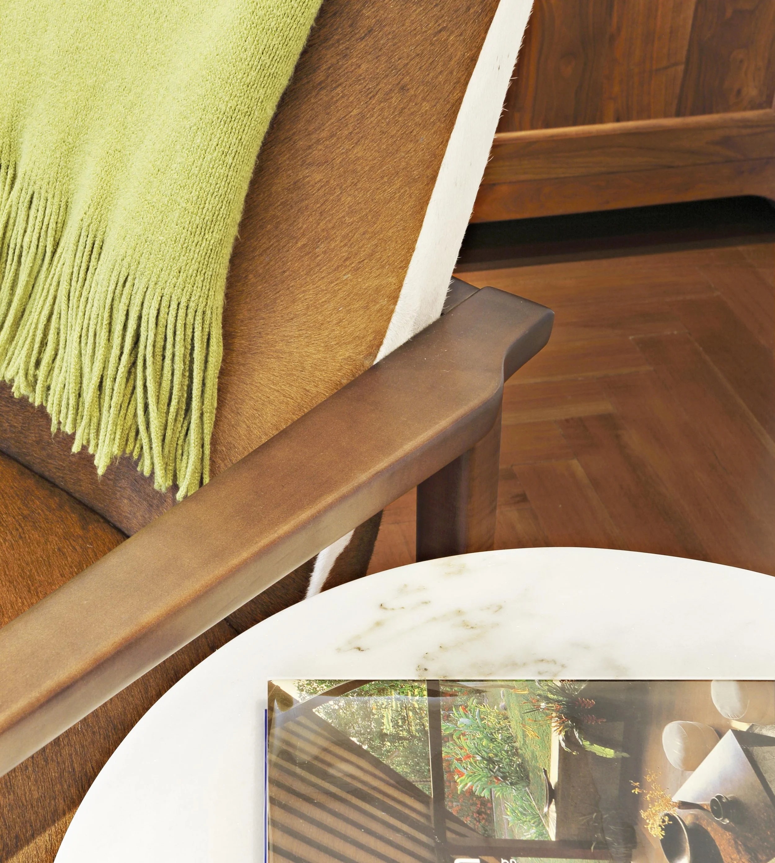 Close-up of accent chair paired with side table in family room seating area.