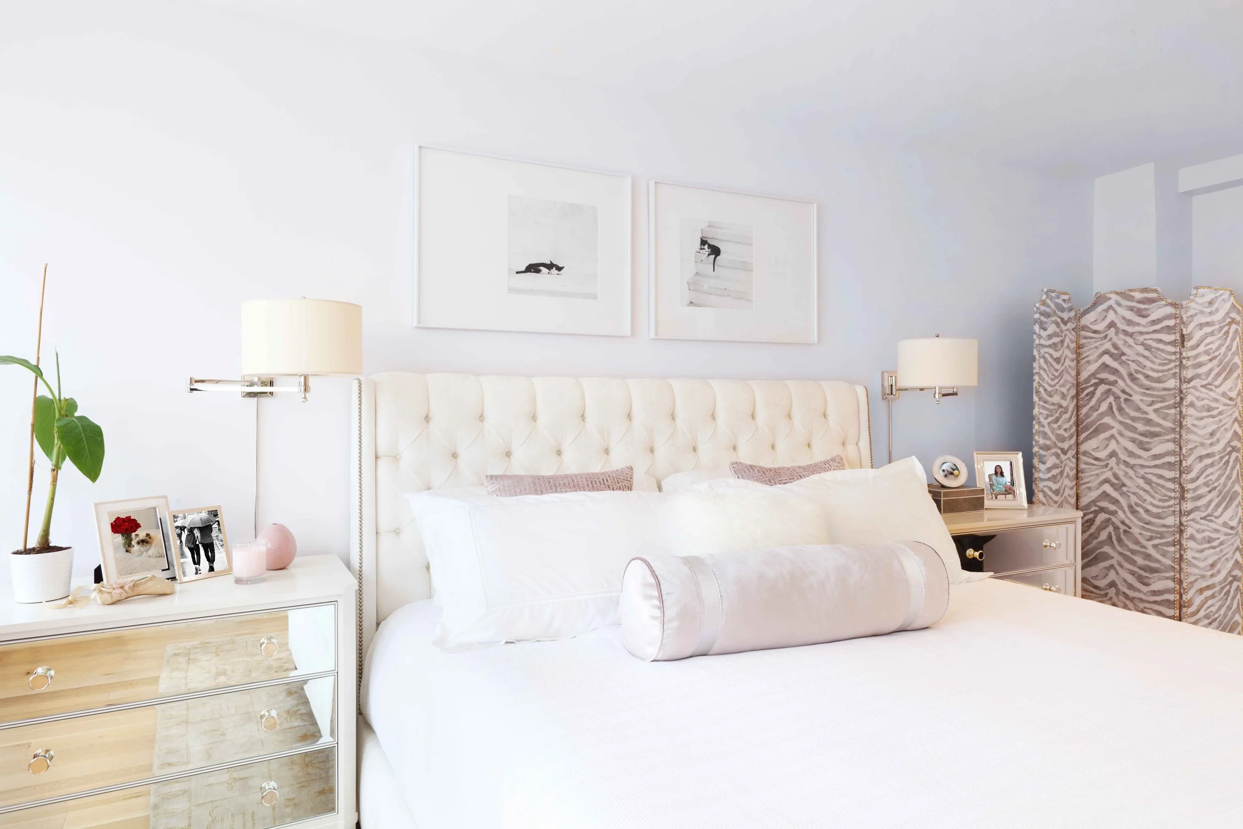 Primary bedroom with refined furnishings and upholstered screen in Doyer Apartment in White Plains, NY.
