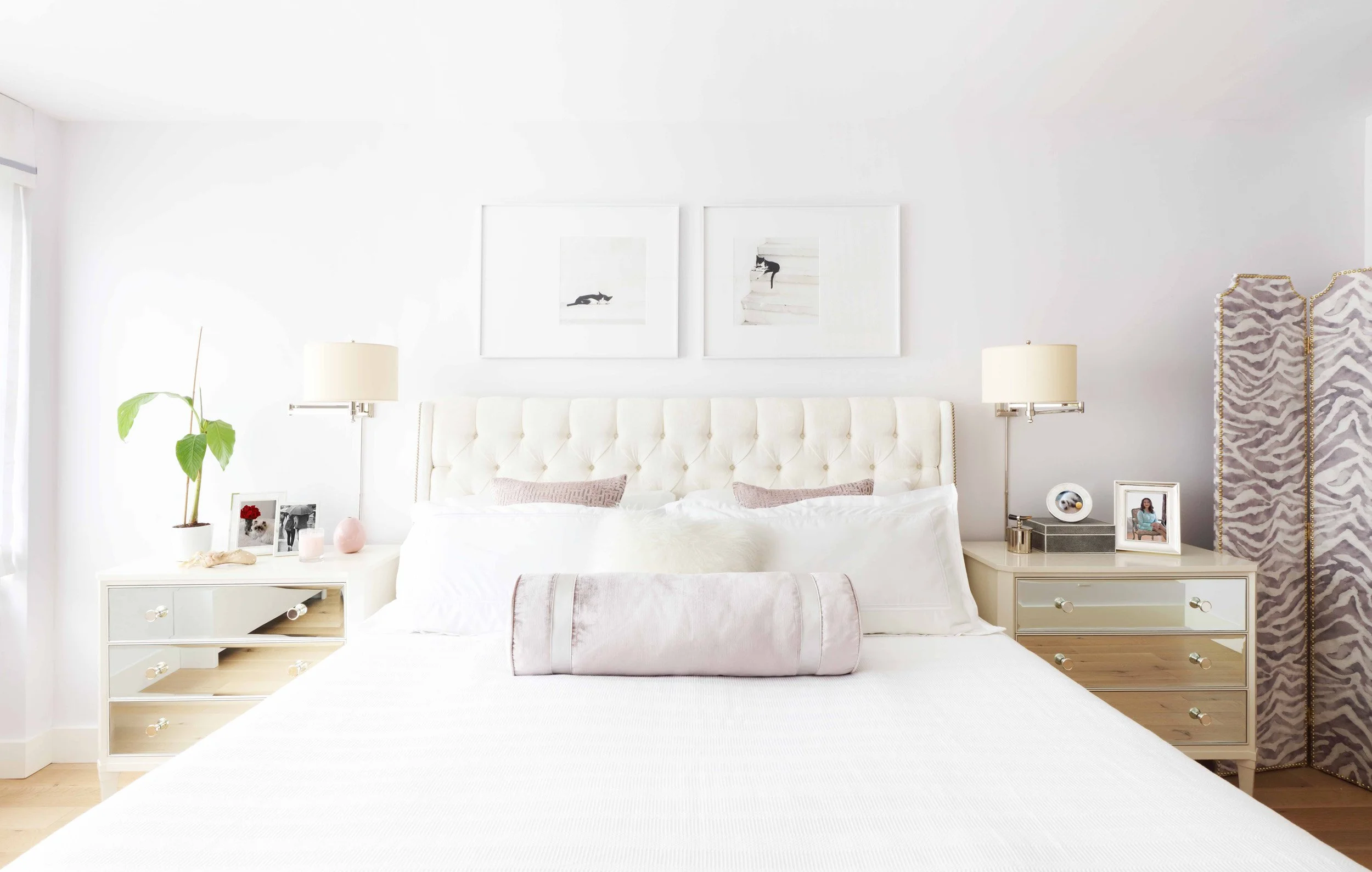 Primary bedroom with expansive window, light flooring, and refined furnishings in Doyer Apartment in White Plains, NY.
