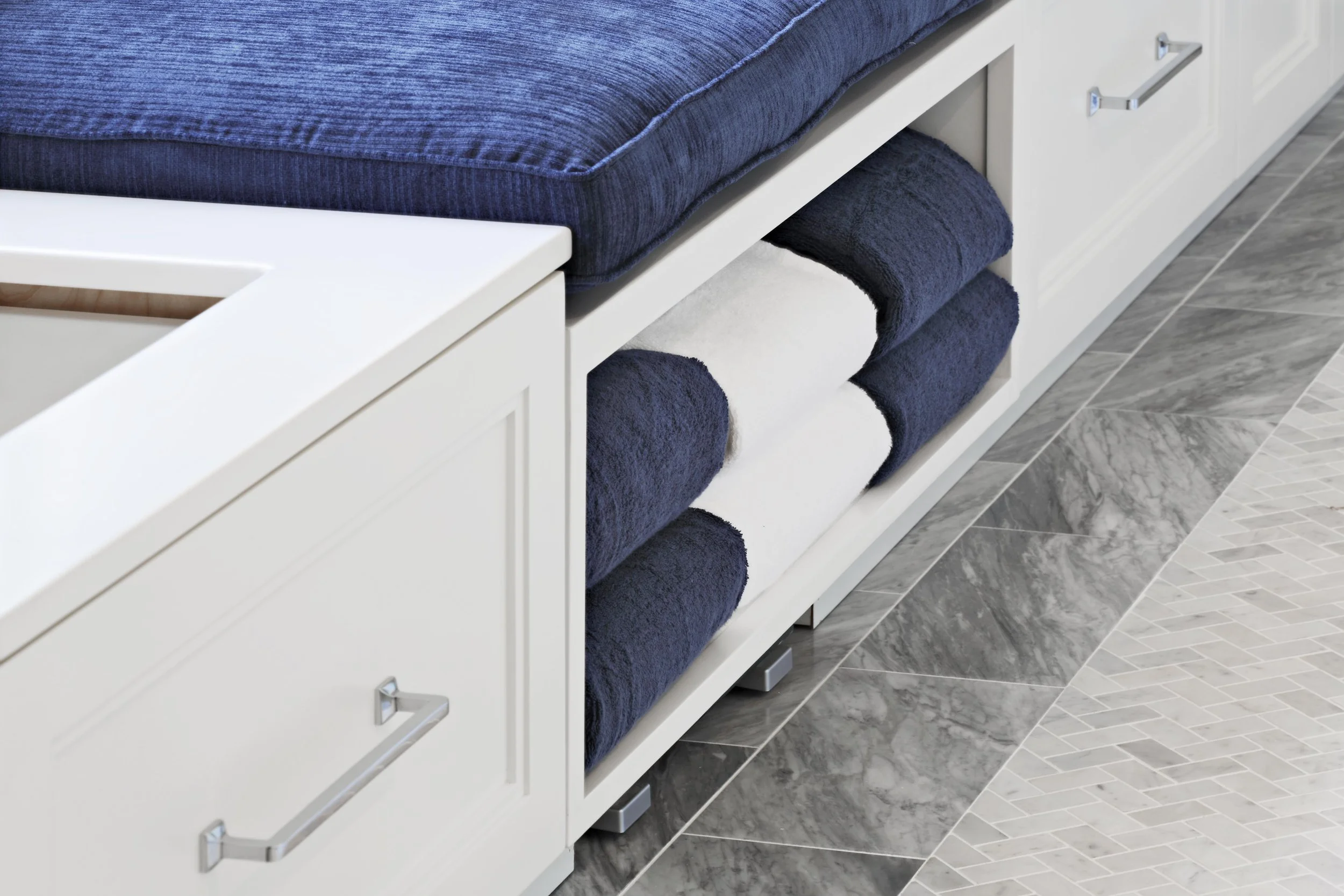 Close-up of a built-in bathroom bench with integrated laundry hamper in a Jack and Jack bathroom at the Dann Farm residence in Pound Ridge, NY.