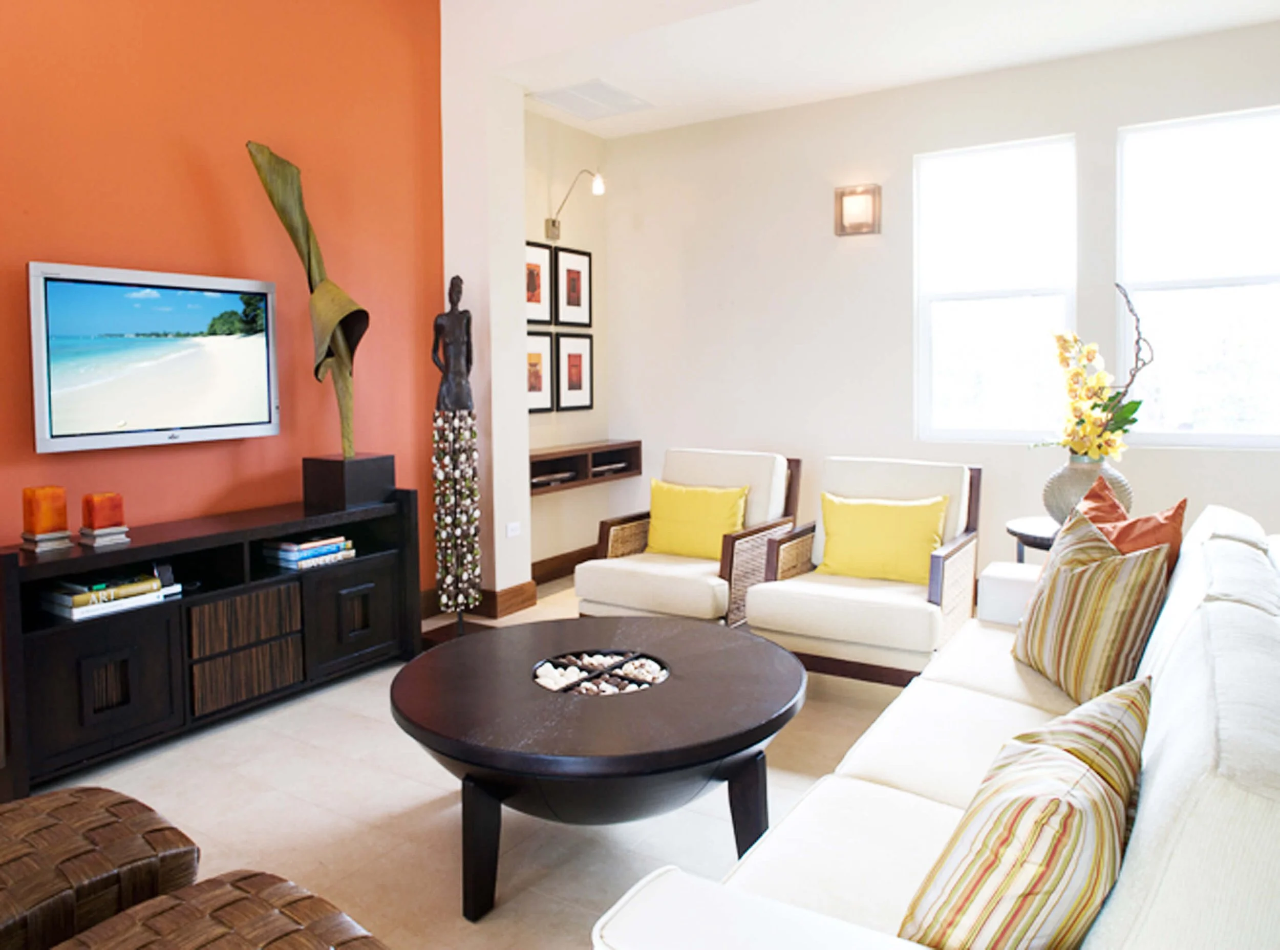 Living room interior of guest villa in Grand Cayman with coastal furnishings and warm tones.