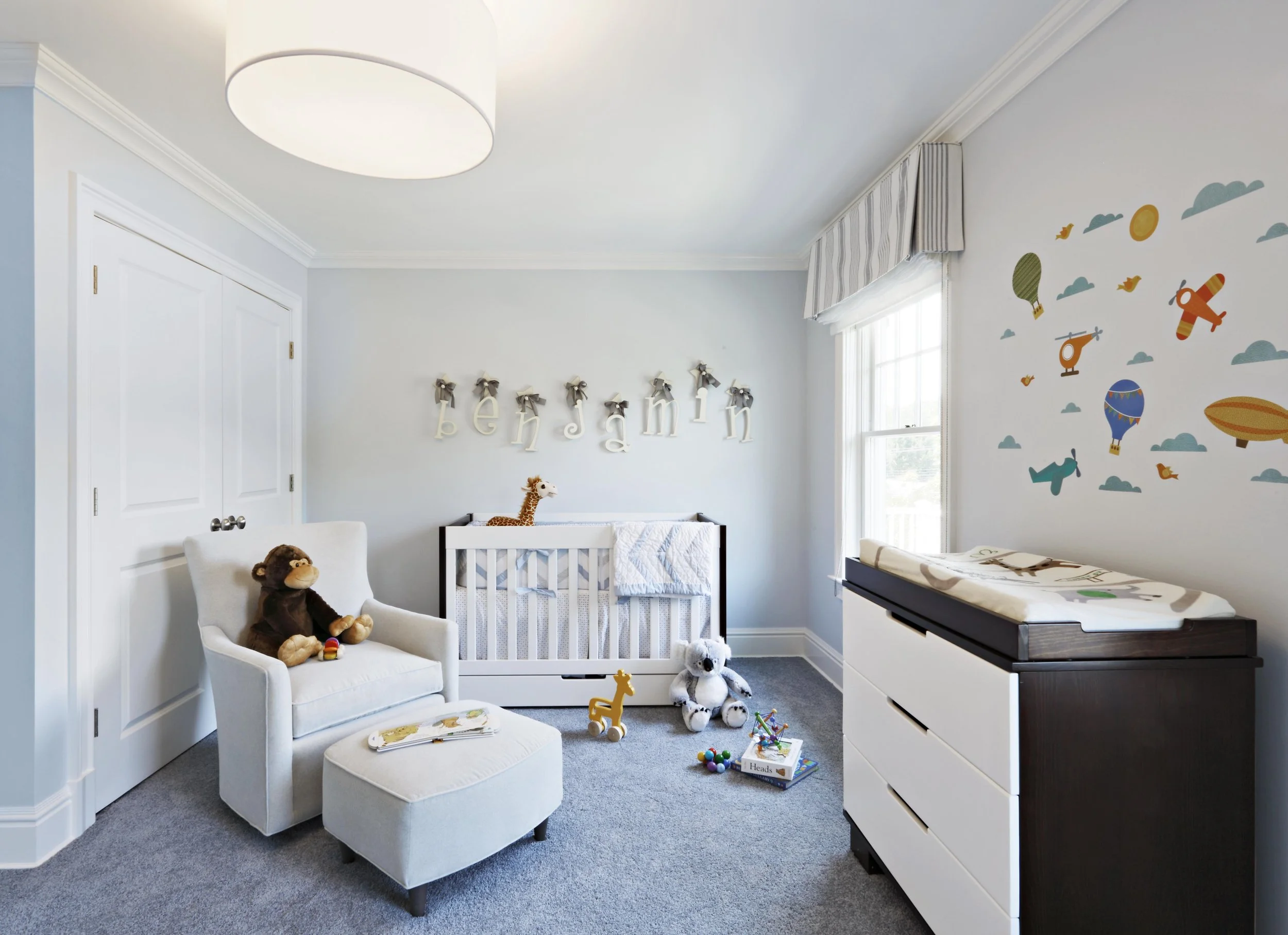 Boy’s bedroom in Parkfield House in Scarsdale NY home featuring soft neutral finishes and tailored furnishings by Luminosus Designs.