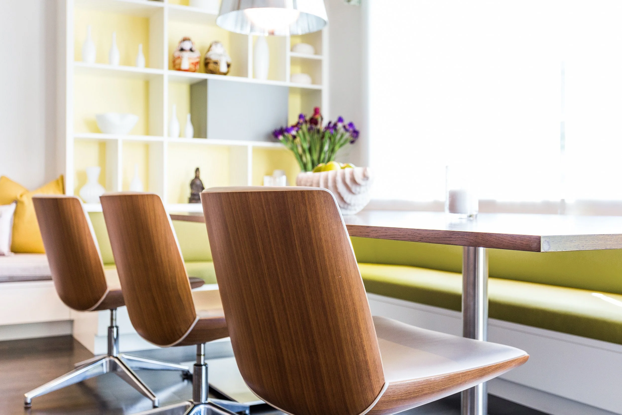 Close-up view of dining chairs paired with the built-in banquette for casual breakfast seating in Kensett House, Darien CT.