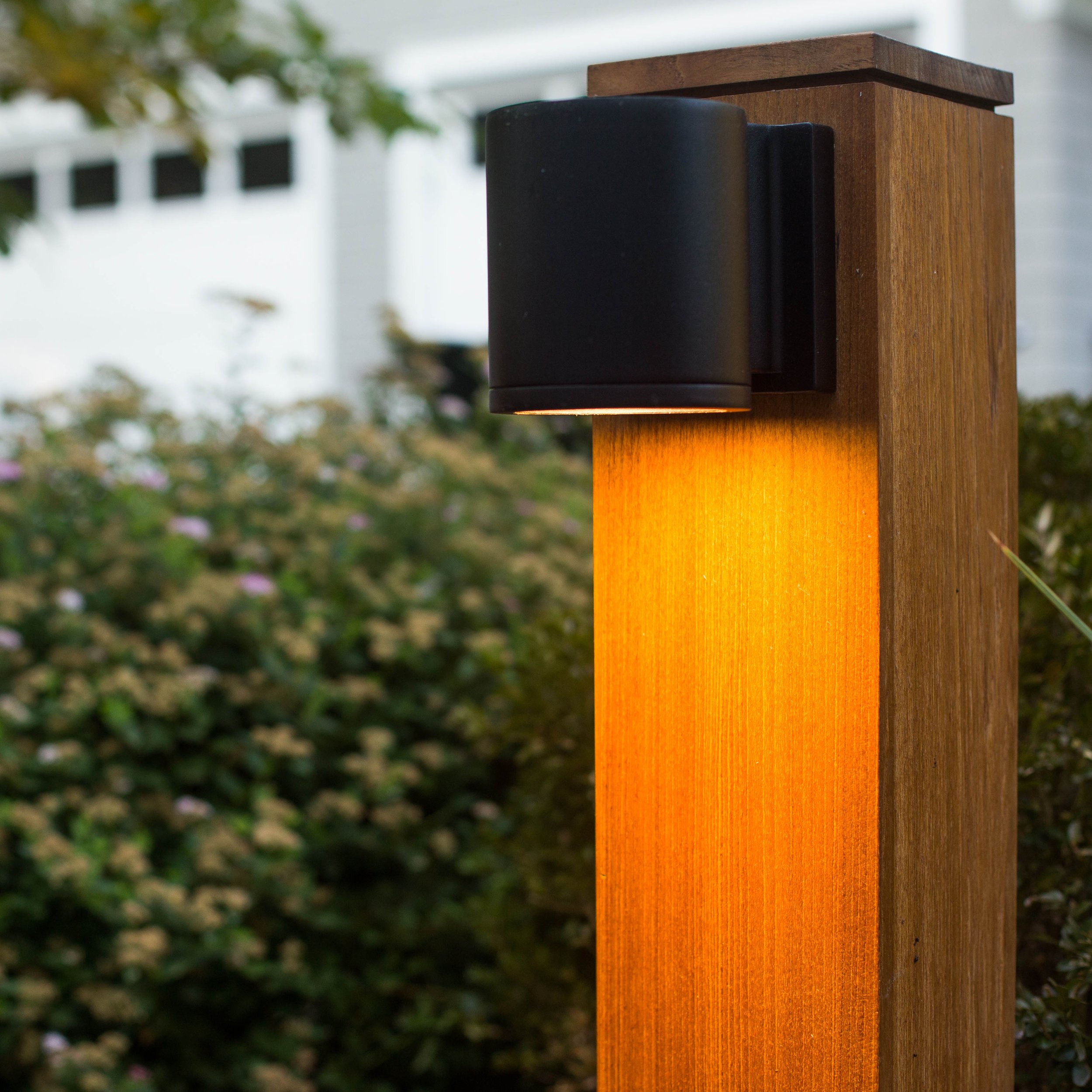 Detail of lighting on custom wood post in the outdoor kitchen at the Indian Field Outdoor project in Greenwich, CT.