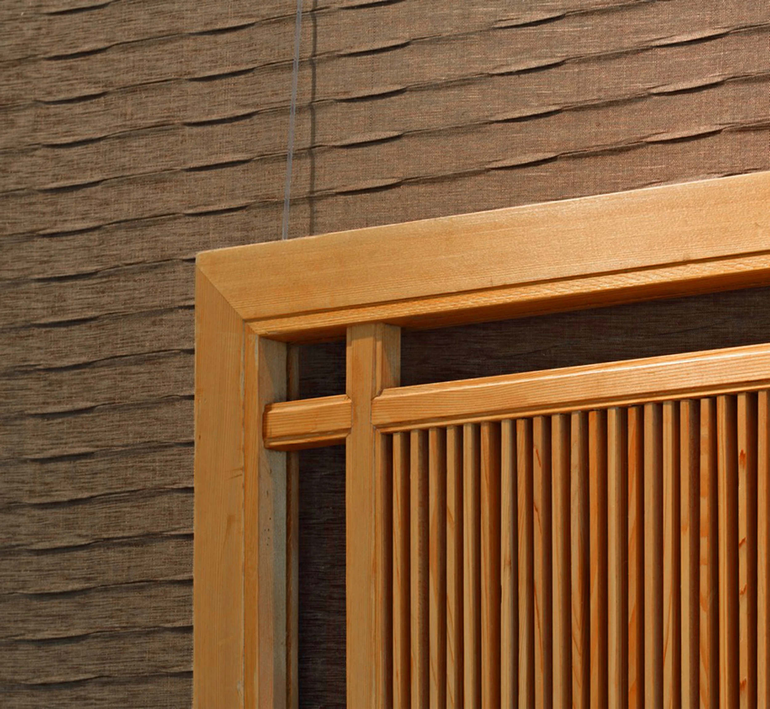 Antique screen detail displayed above the headboard in primary bedroom in Indian Field residence in Greenwich, CT.
