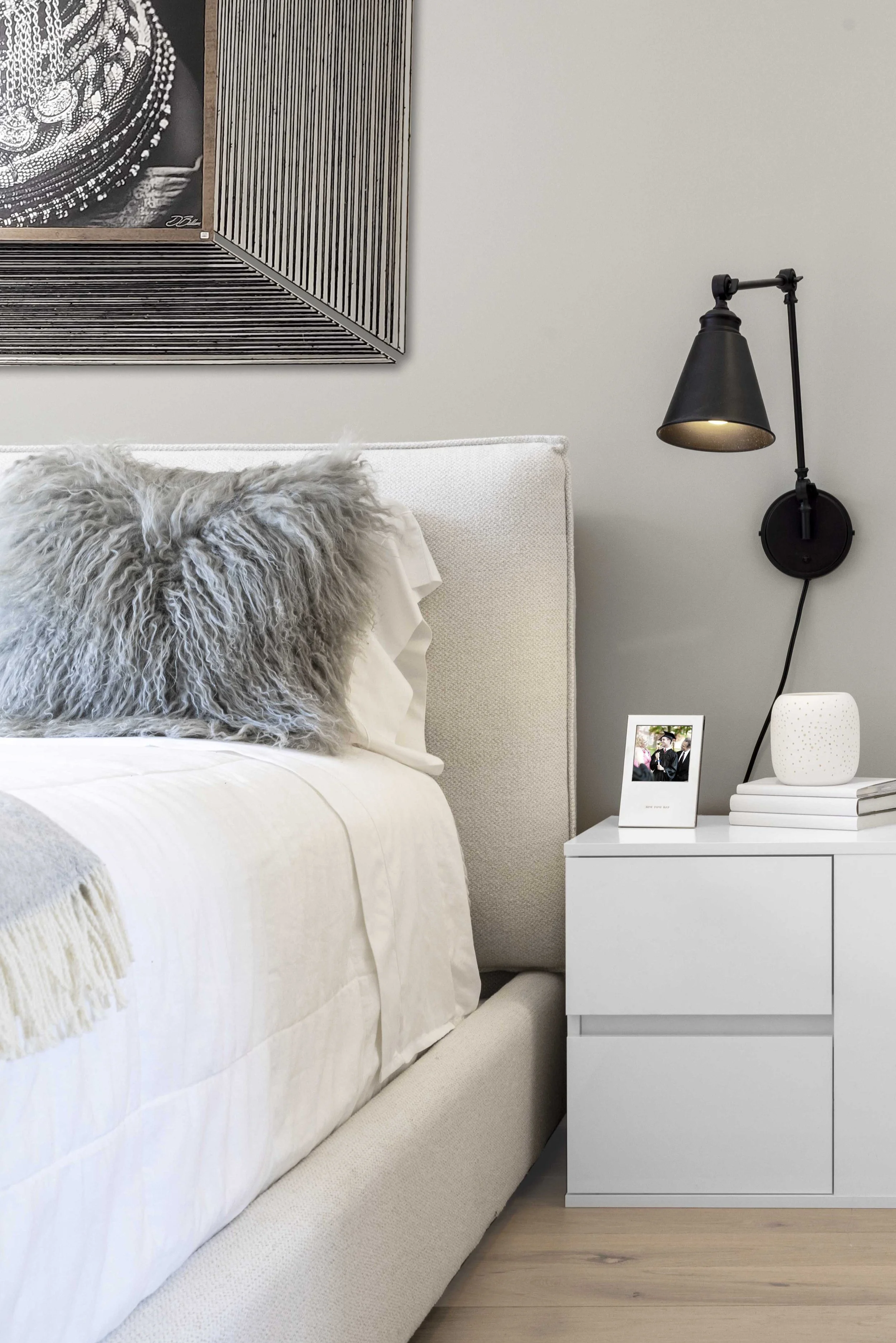Close-up of the headboard and layered bedding in the Gramercy Arms NYC sleeping alcove.