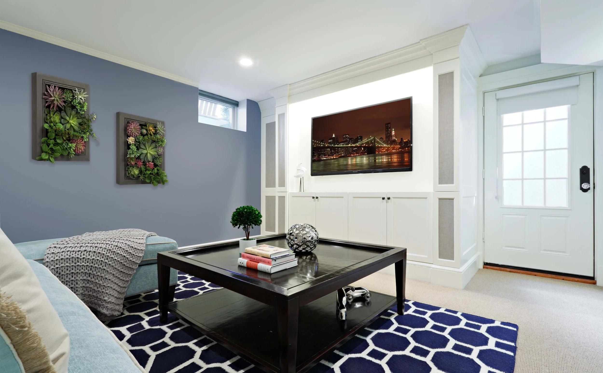 Close-up view of custom media cabinet over chimney ash pit in basement in Indian Field residence in Greenwich, CT.