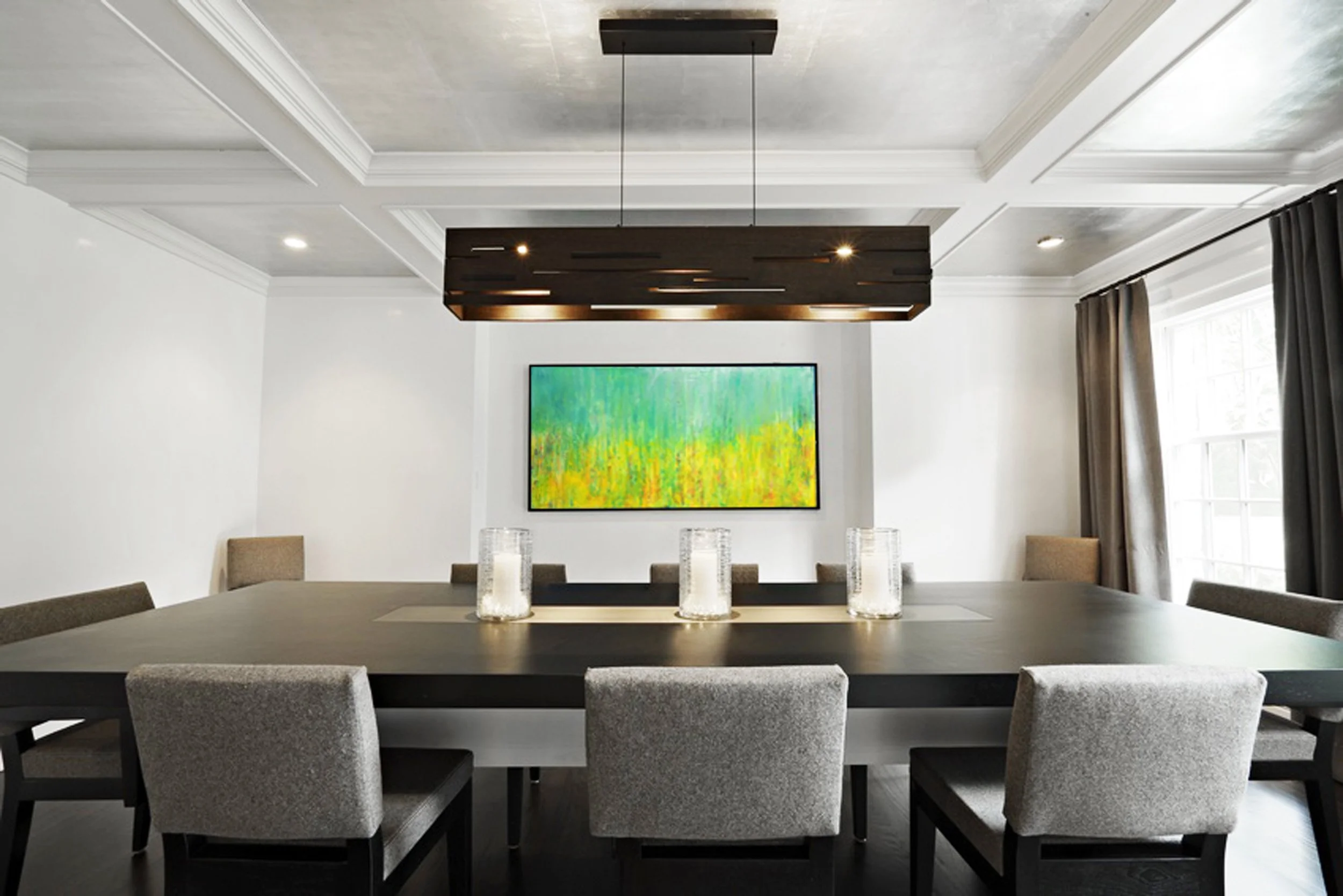 Dining room at the Meeting House in Greenwich, CT featuring a custom dark wood table and contemporary linear chandelier designed by Luminosus Designs.