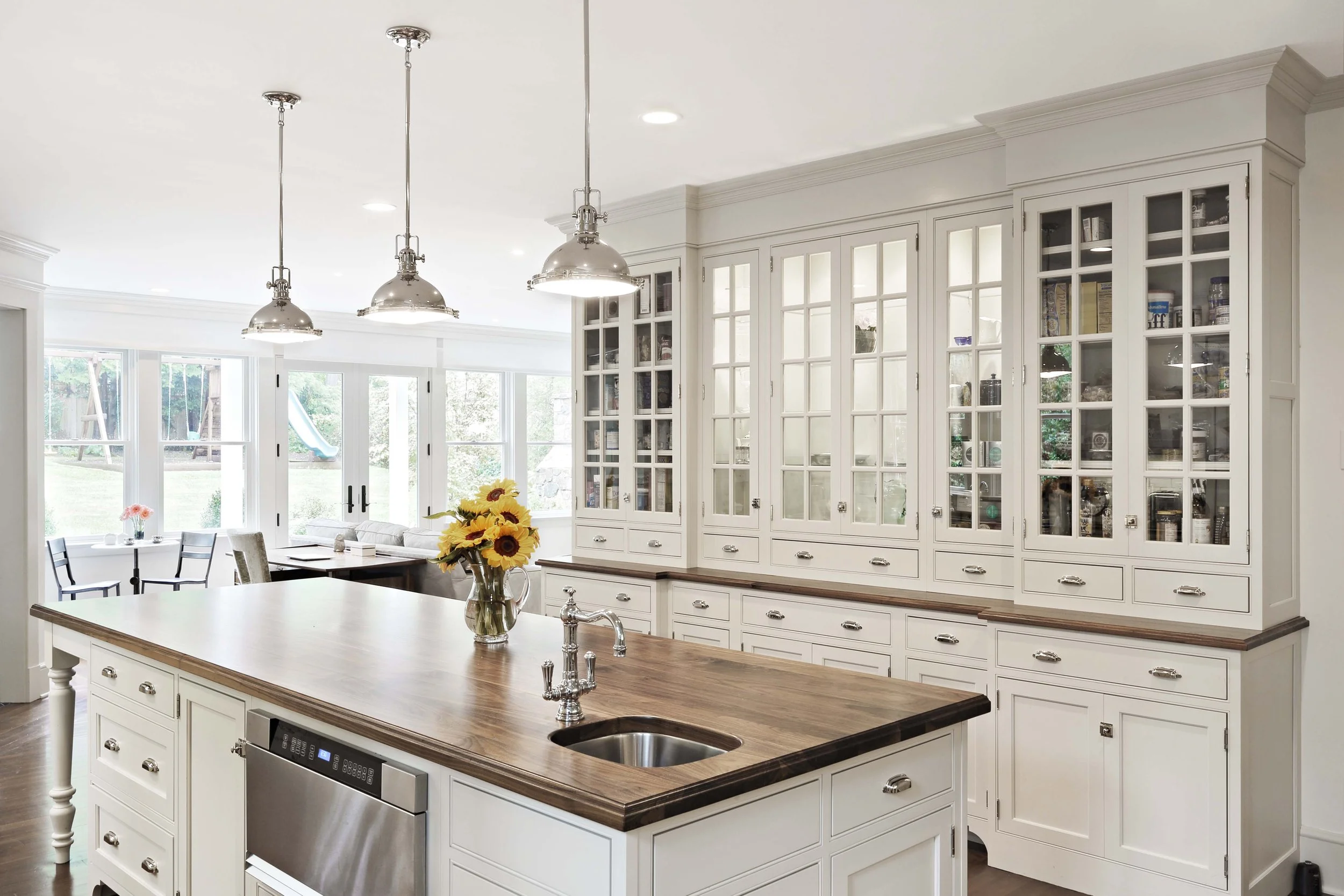 Kitchen lighting design in Greenwich, CT by Luminosus Designs highlighting island and ceiling fixtures.
