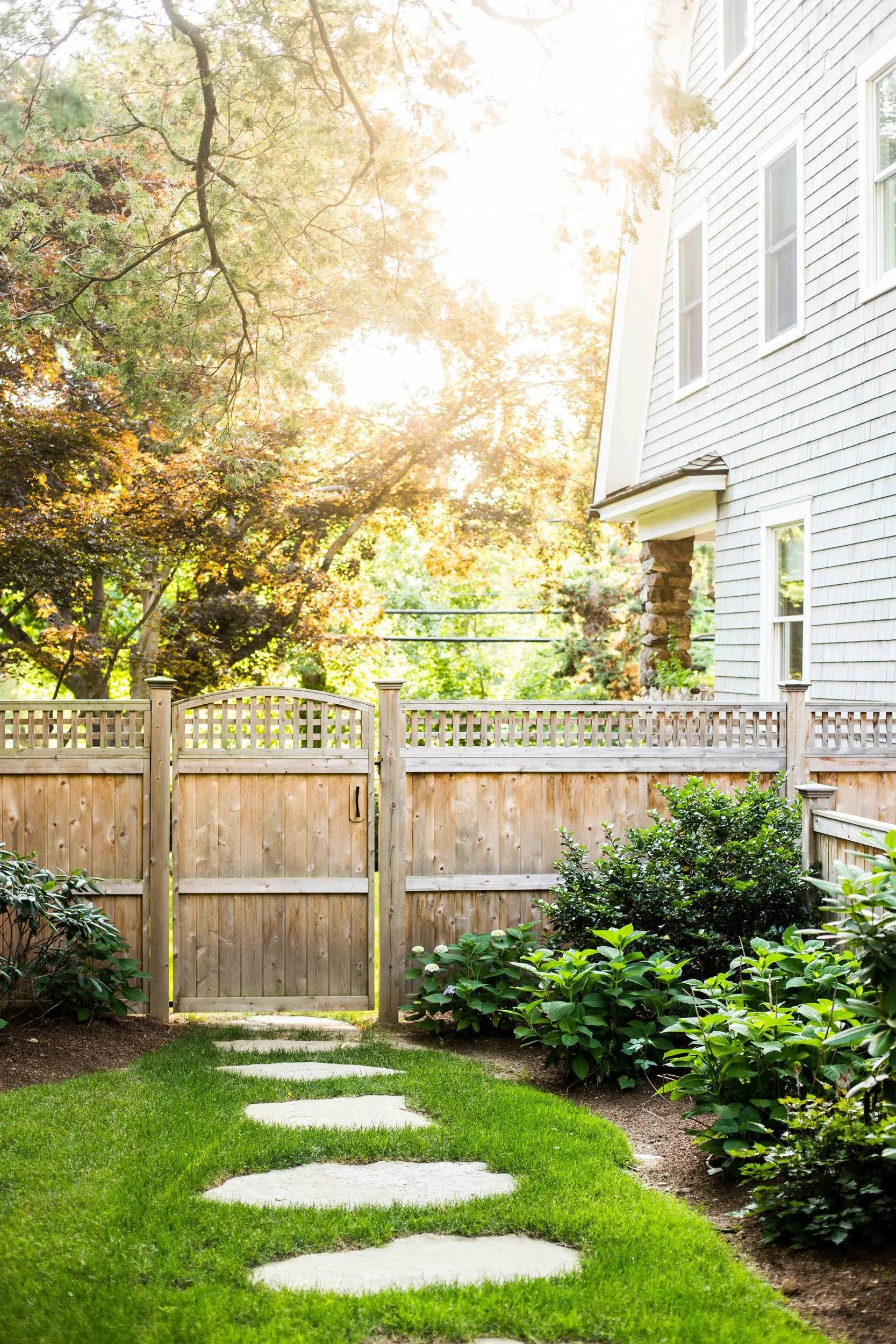 View of stone path and fencing in the garden at the Indian Field Outdoor project in Greenwich, CT.