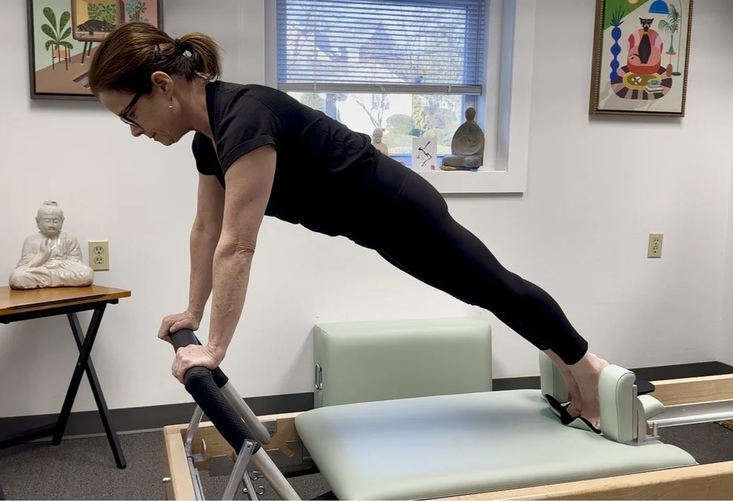 Jennifer Pollack performing the Long Stretch exercise on a classical Pilates Reformer in Westport, Connecticut showing core strength, alignment, and control.