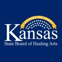Kansas State Board of Healing Arts logo with a blue background, white text, and gold accents, including a gold banner with stars.