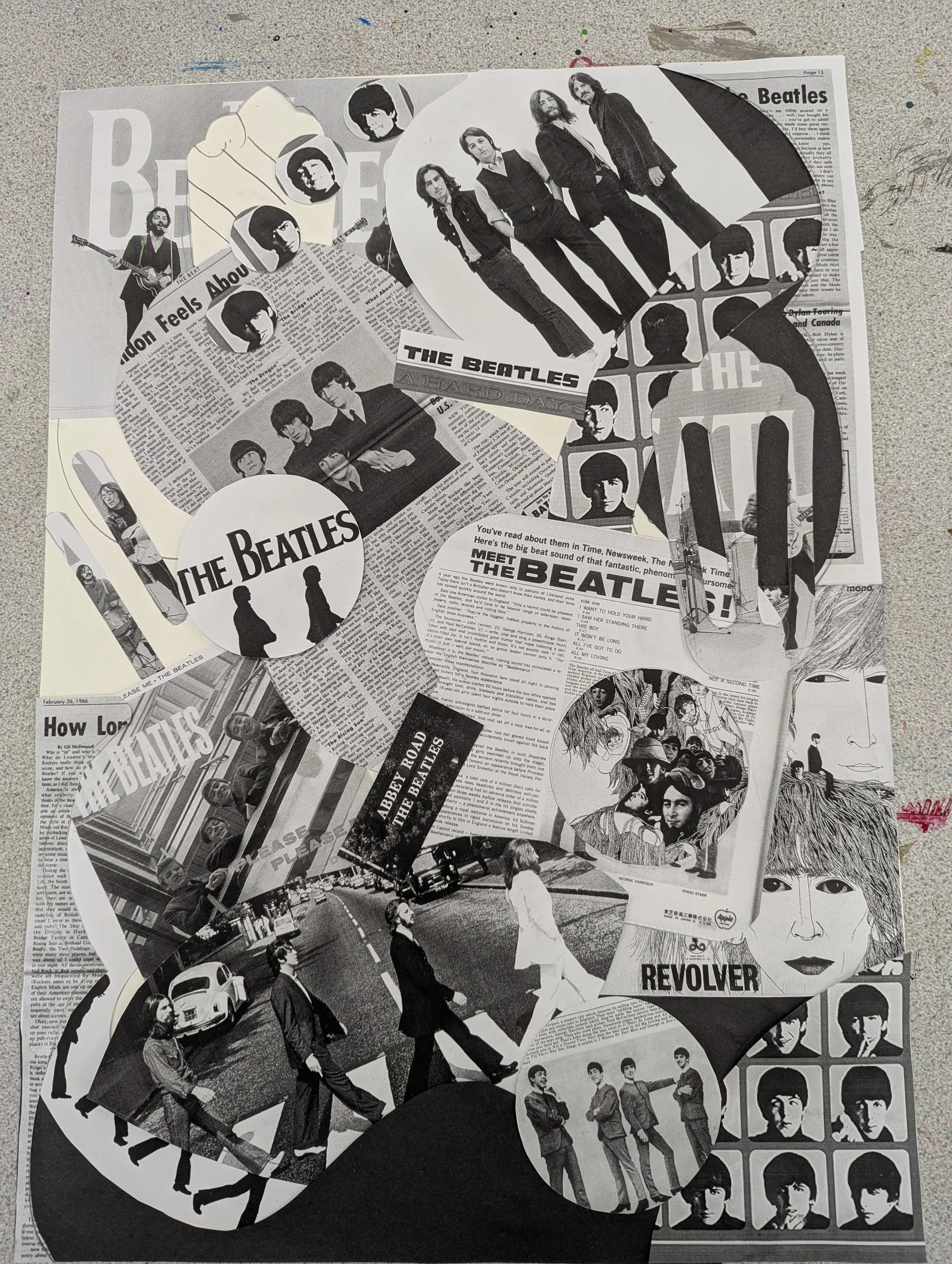 Collage of The Beatles images, newspaper articles, album covers, and band photos arranged on a surface.
