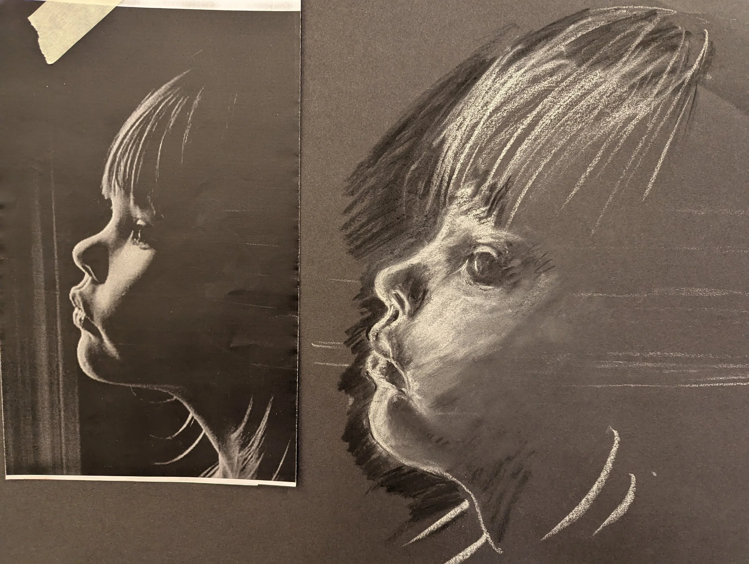 A black and white chalk drawing of a person's profile, showing detailed facial features.