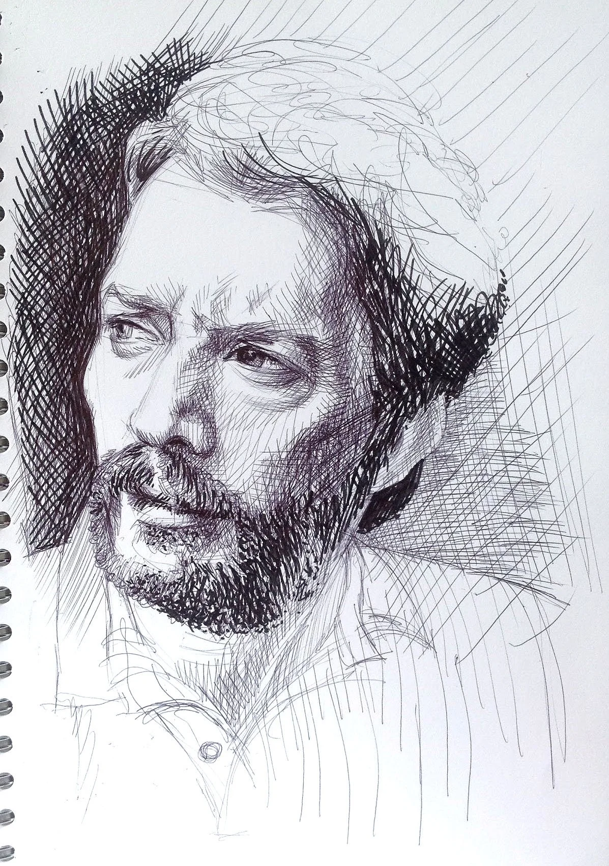 Black ink sketch of a man's face with a beard and moustache, looking slightly to the side, with detailed shading and cross-hatching.
