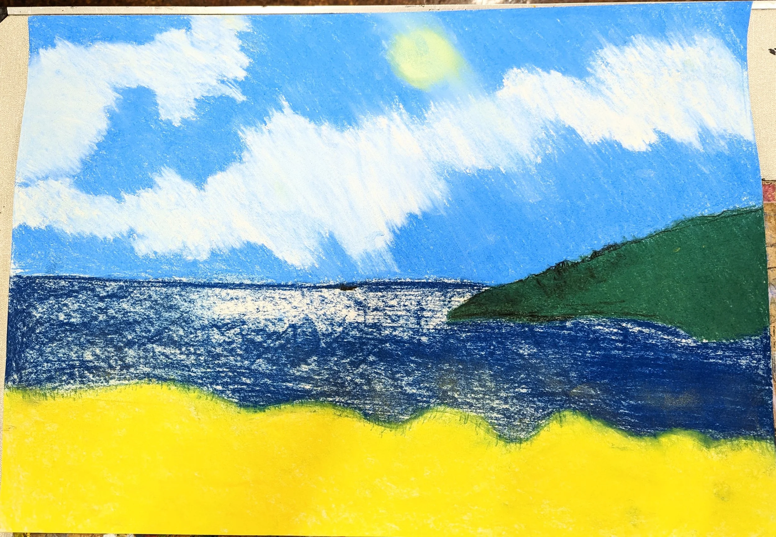 A colourful painting of a seaside landscape with a bright yellow beach in the foreground, blue water, a green hill on the right, and a sky with clouds and a yellow sun.