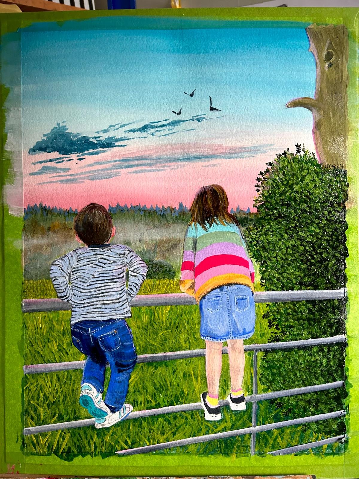 Children standing on a fence, watching birds fly in a pink and blue sunset sky, with trees and a bush nearby.
