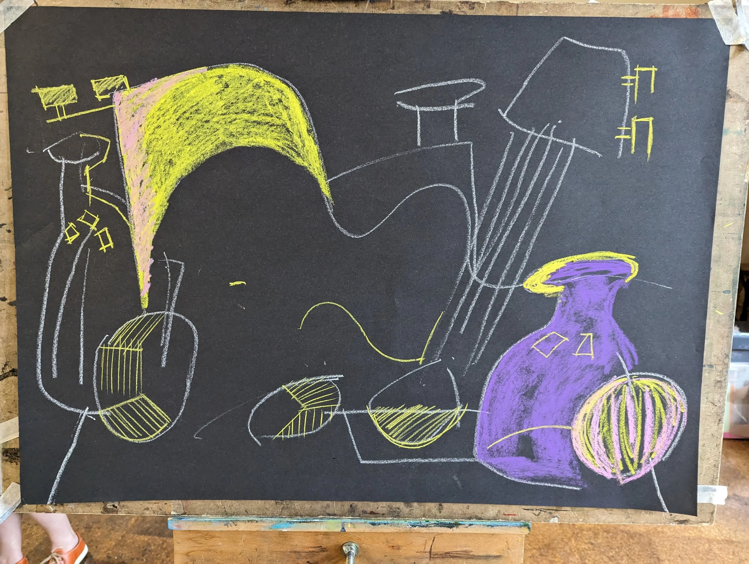 A chalk drawing on black paper of a guitar, vase, pumpkin, and various abstract shapes in yellow, purple, and white.