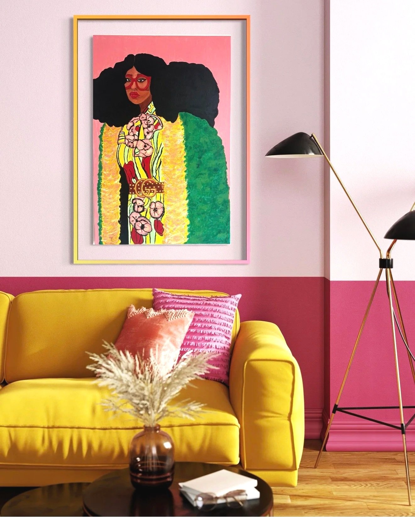 Interior of a living room with a yellow sofa, pink wall, and colorful artwork of a woman with large curly hair and glasses. There are pink and orange pillows on the sofa, a black coffee table with a vase of dried flowers, a black wall-mounted lamp, and a pink window shade.