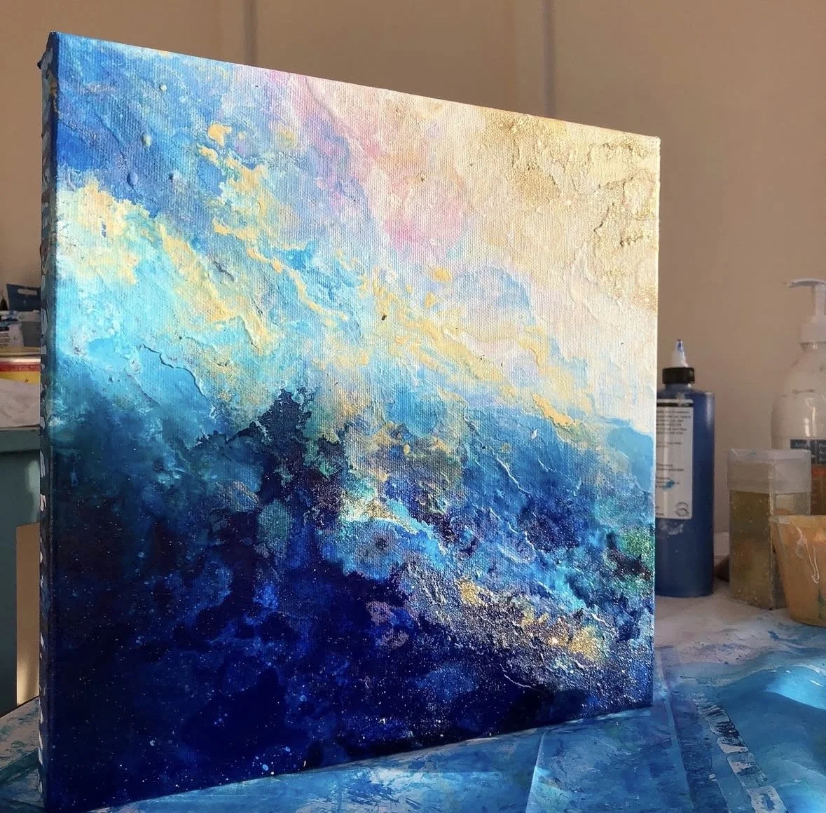 Abstract blue and gold oceanic painting "Emergent Depth" by Dana Savoca Tietze