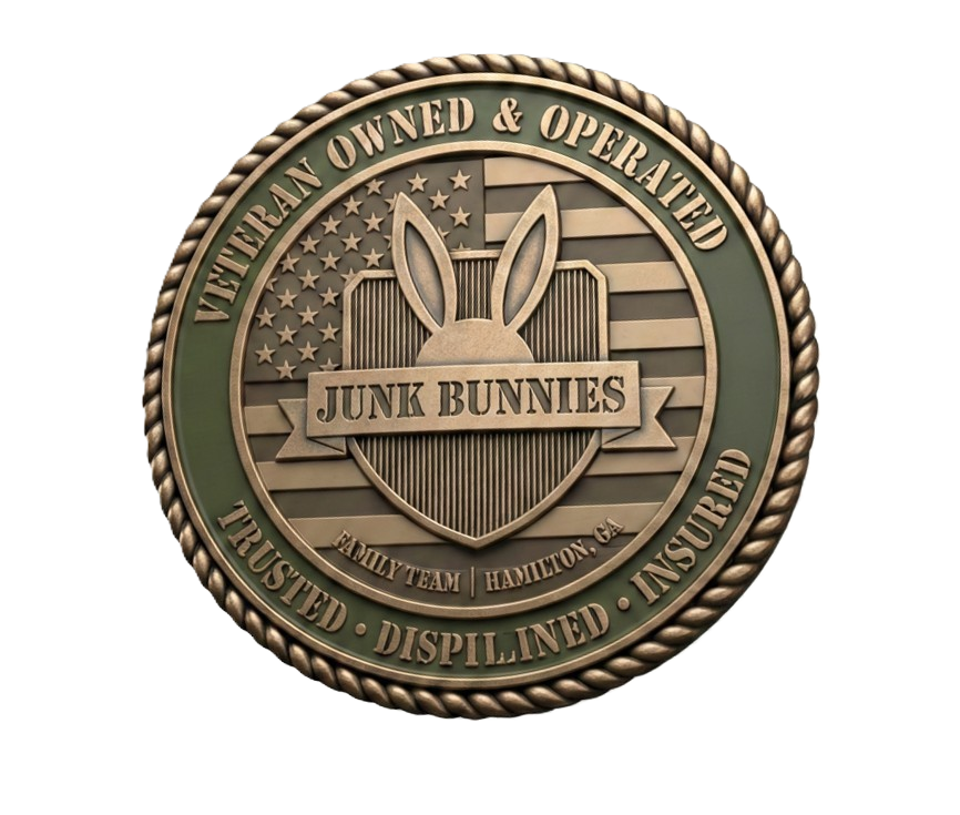 Medal with a shield in the center reporting the name 'Junk Bunnies,' featuring bunny ears above the shield, with the American flag in the background. The shield is topped with a star, and a ribbon with the name 'Junk Bunnies' across it. The border of the medal reads 'Veteran Owned & Operated,' 'Trusted,' 'Disciplined,' 'Insured,' and 'Family Team - Hamilton, GA'.