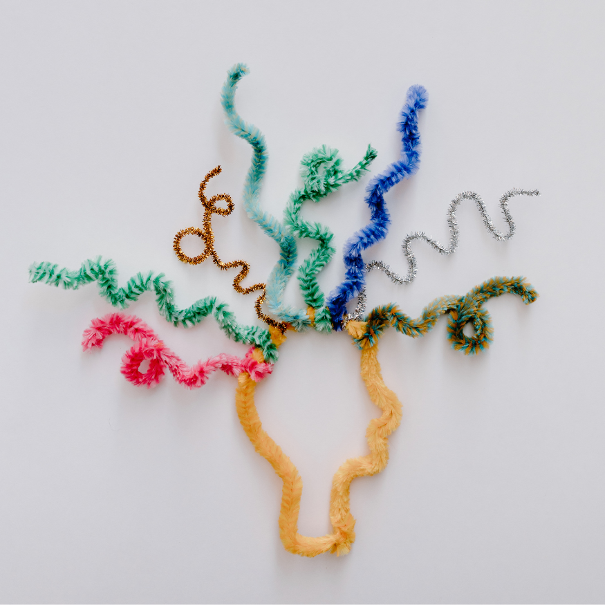 Two women sitting on a couch having a conversation, with one woman holding a smartphone.