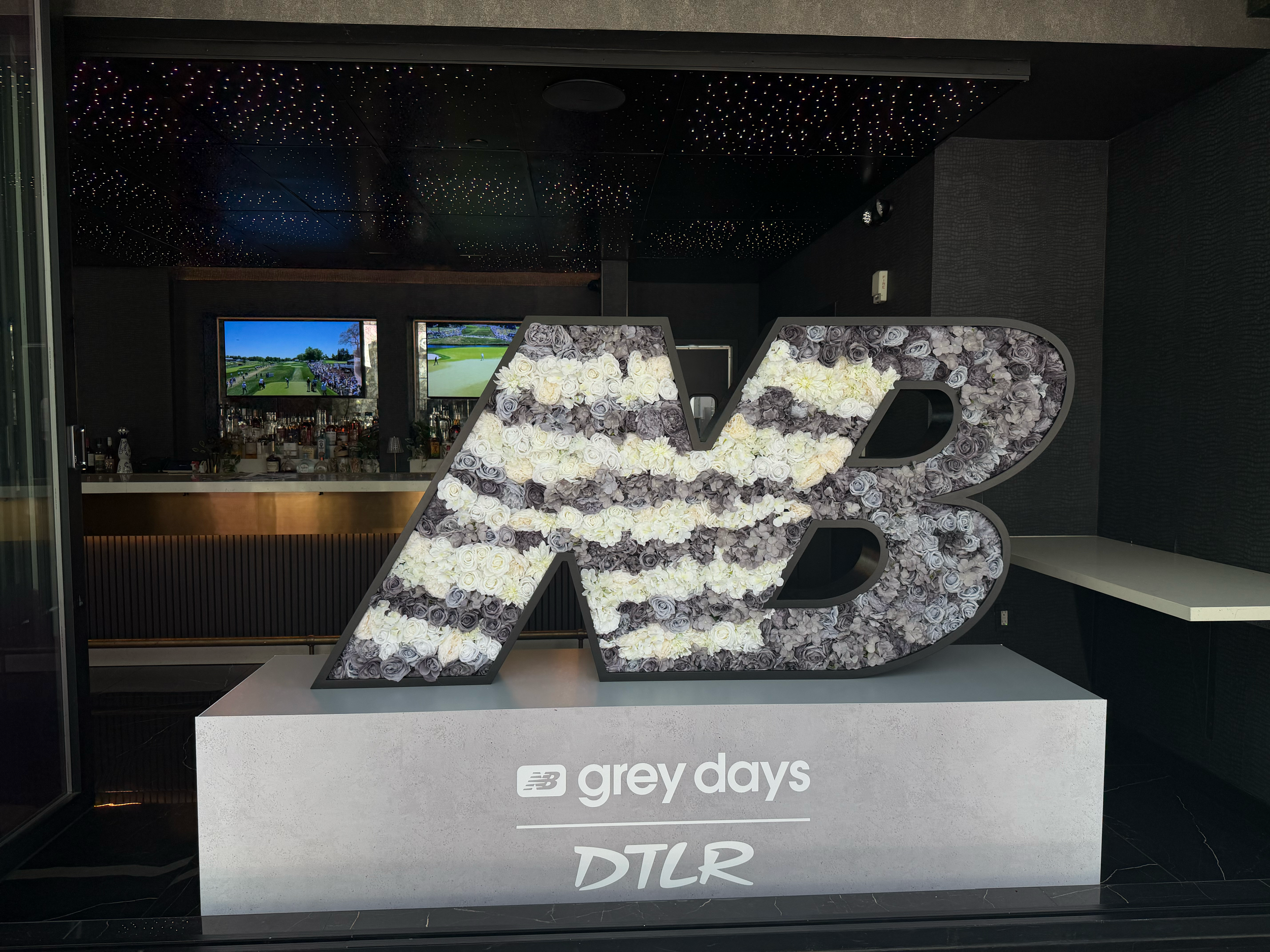 A retail store display of New Balance Logo Floral Arrangement