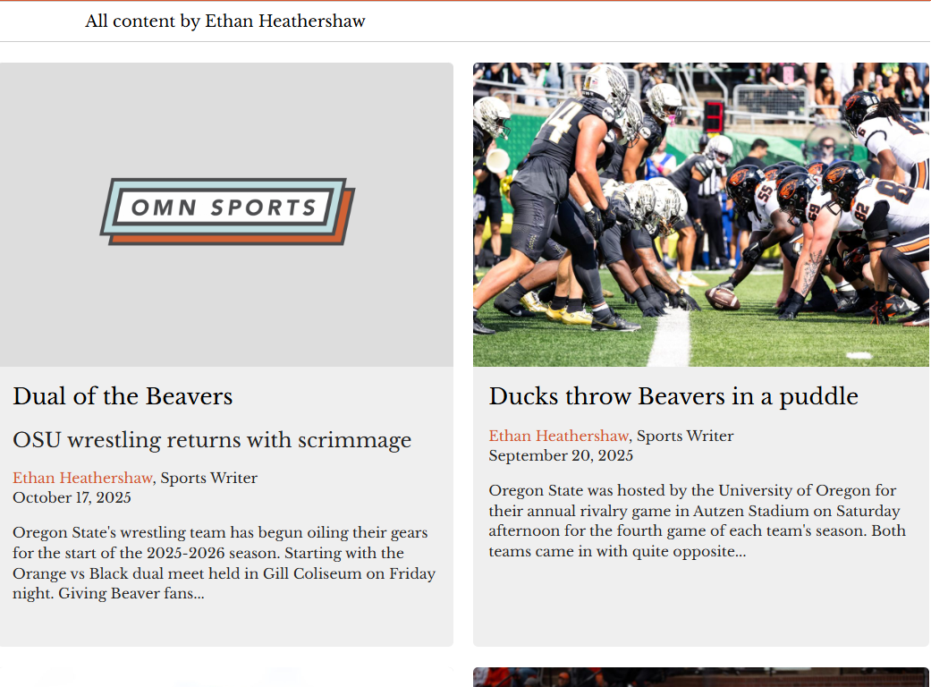 American football team engaged in a game on the field with players lined up against each other in a ready stance. Spectators are visible in the background.