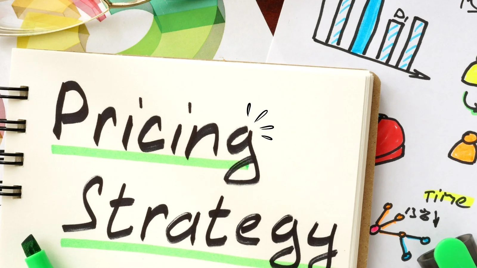 A notebook with the words 'Pricing Strategy' written on it, surrounded by colorful drawings and highlighters.