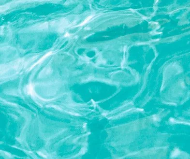 Close-up of clear, rippling ocean water with sunlight reflections.