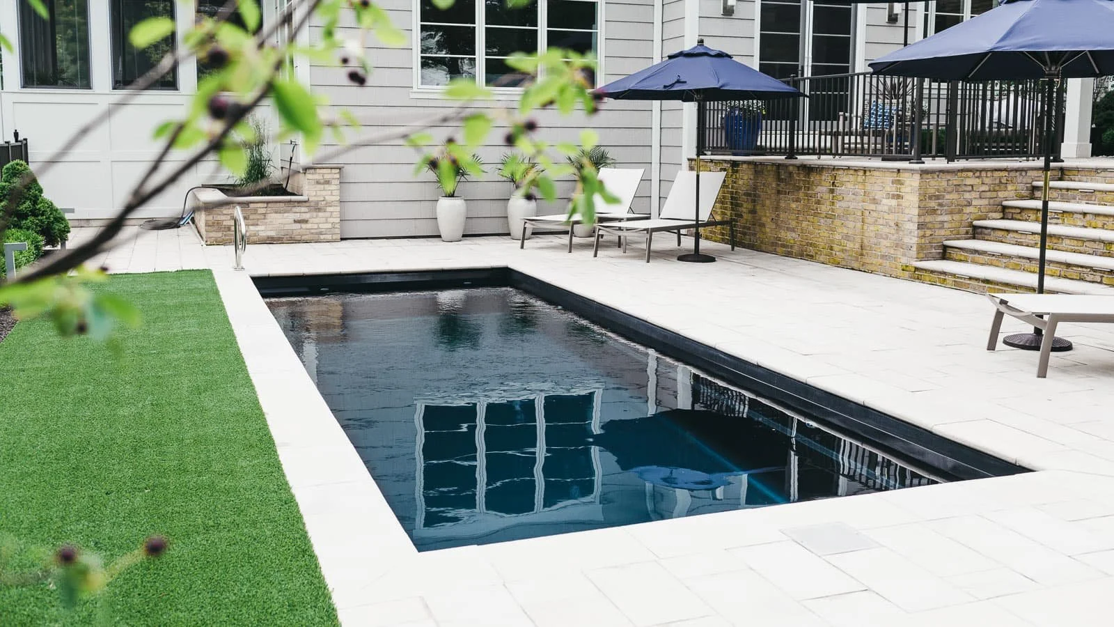 Agave Pool Company compact fiberglass pool designed for smaller East Texas backyards with wide entry bench and efficient swim layout.