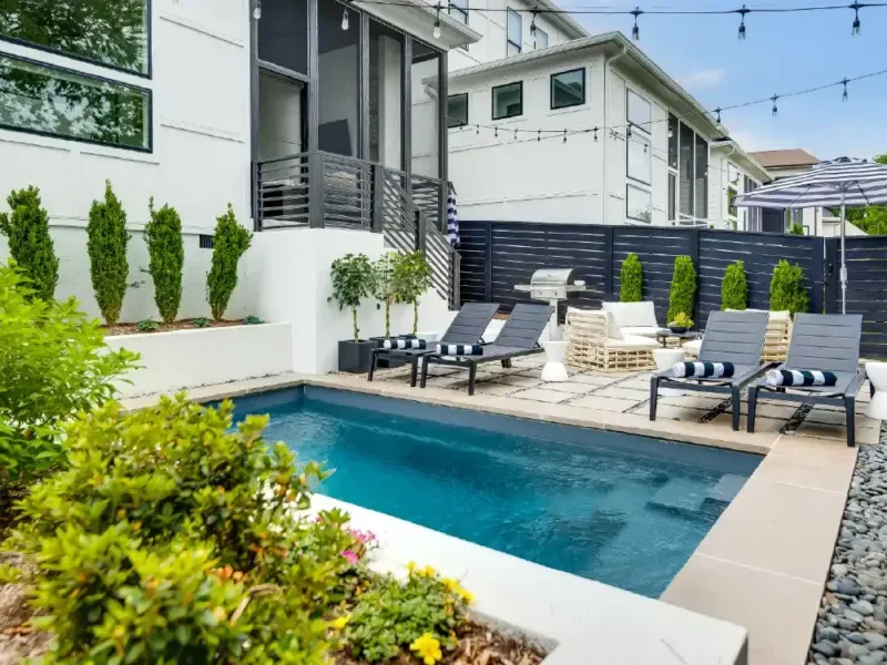 Small backyard fiberglass pool design maximizing outdoor space