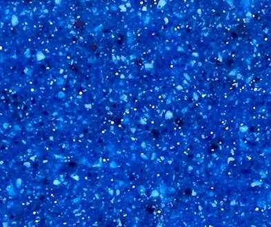 Close-up of a glittery blue surface with sparkling particles.