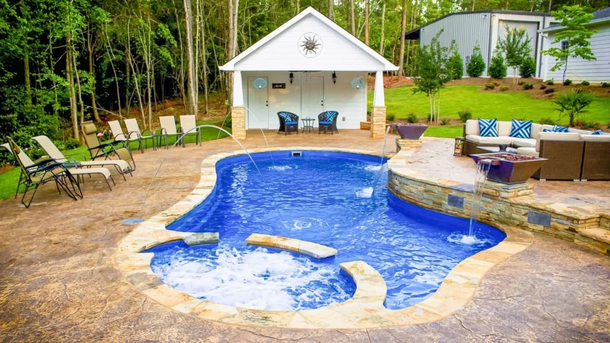 Agave Pool Company luxury fiberglass pool combining spa, splash pad, and swimming area for complete East Texas backyard resort experience.